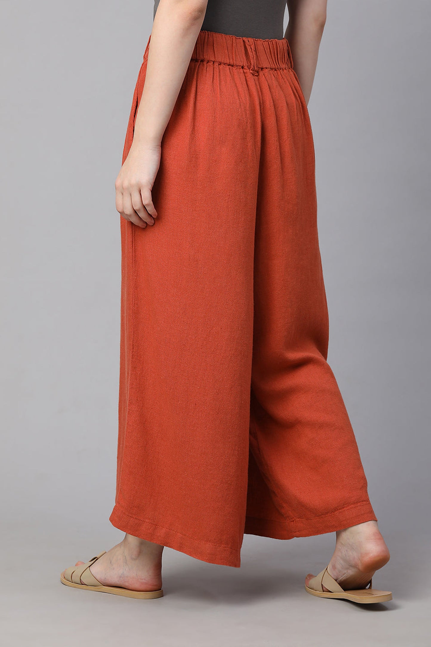 Women wearing rust-colored regular fit culotte pants with a relaxed silhouette and comfortable waistband
