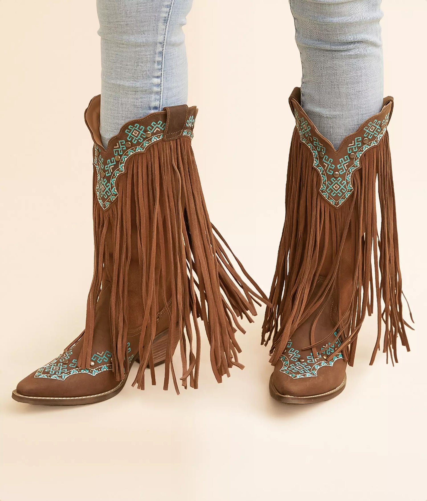 Turquoise leather cowboy boots with fringe and intricate embroidery design for a stylish western look