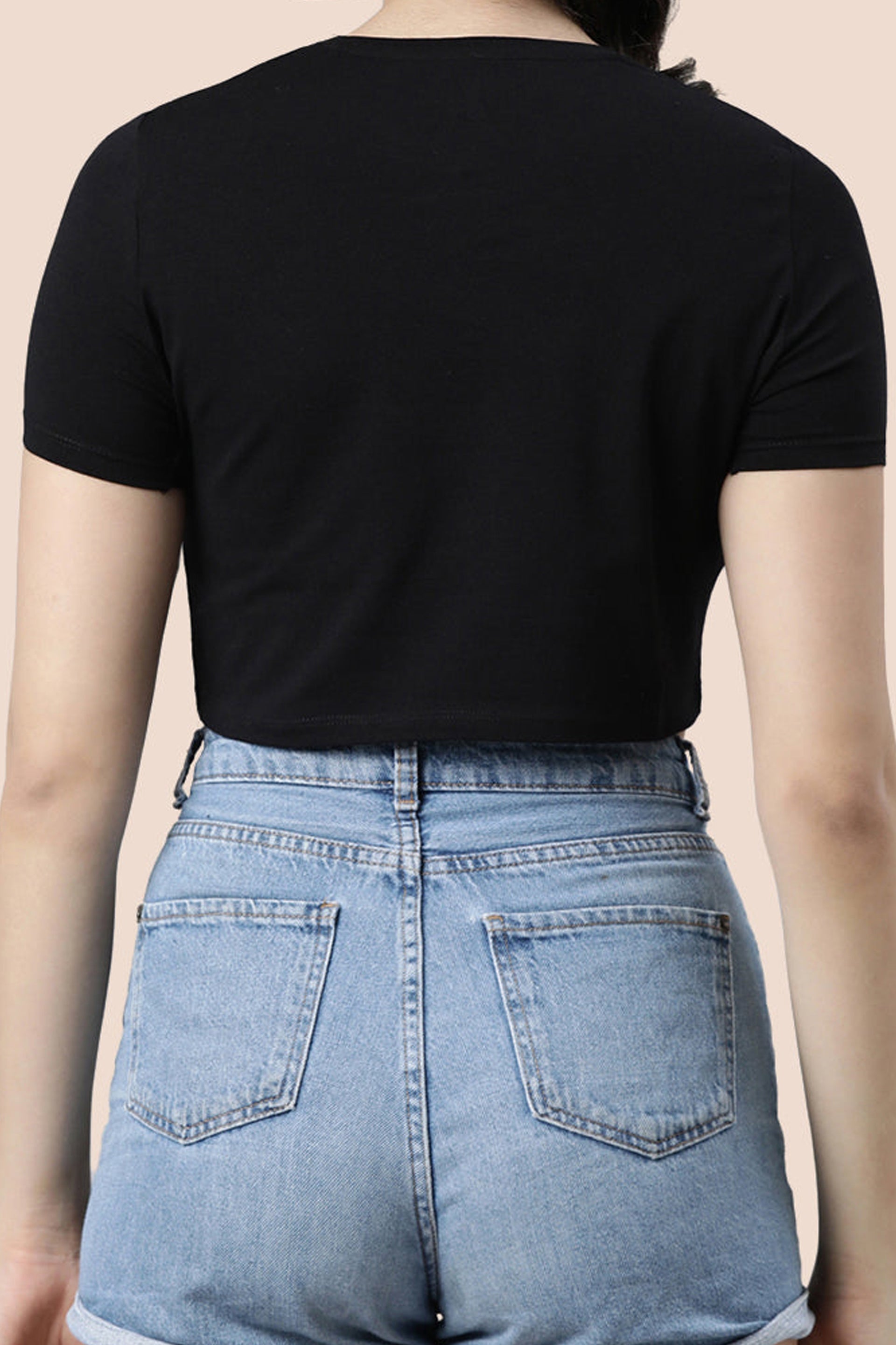 Back view of a stylish women's fashion crop top paired with high-waisted denim shorts