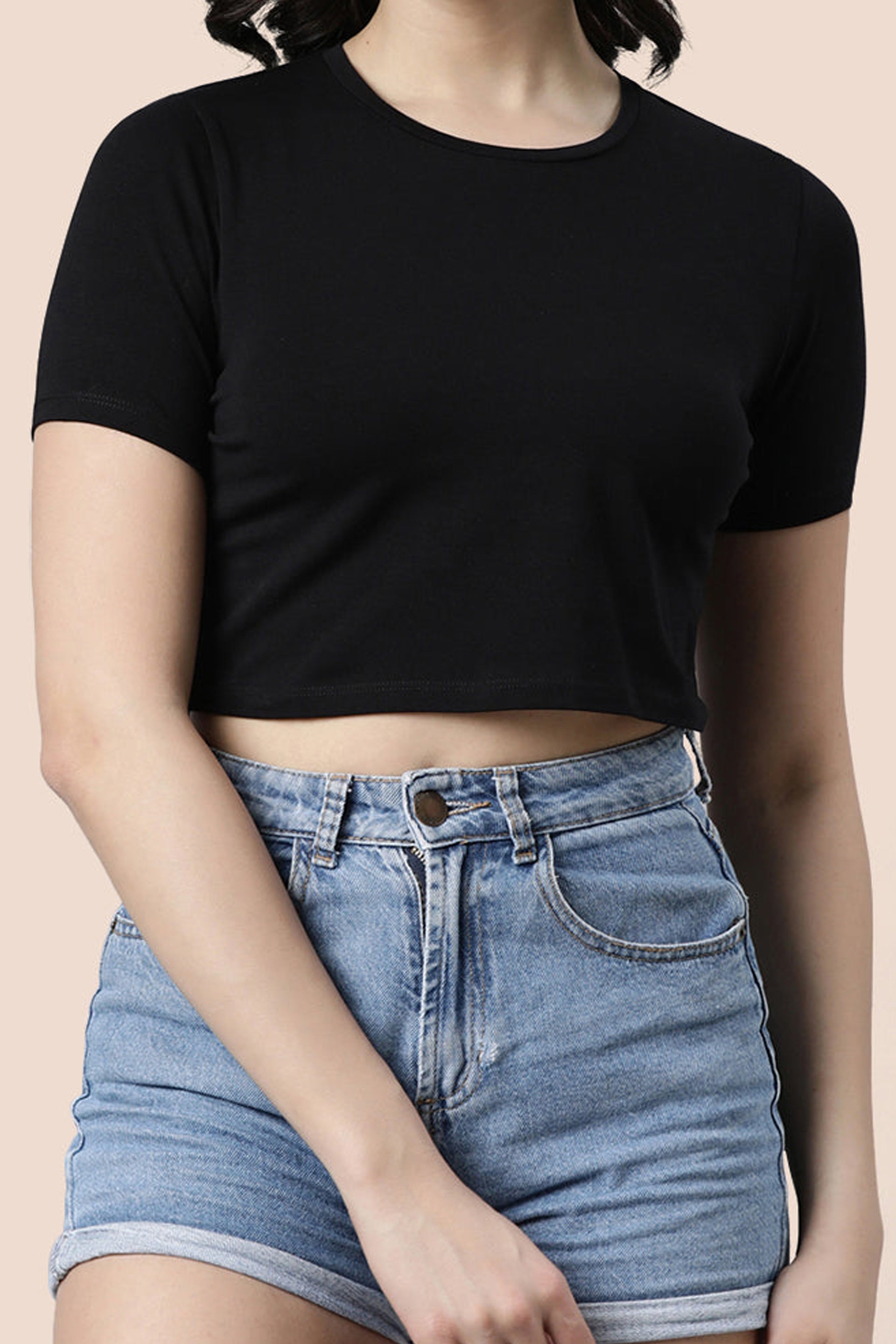 Black women's fashion crop top paired with high-waisted denim shorts for a trendy look