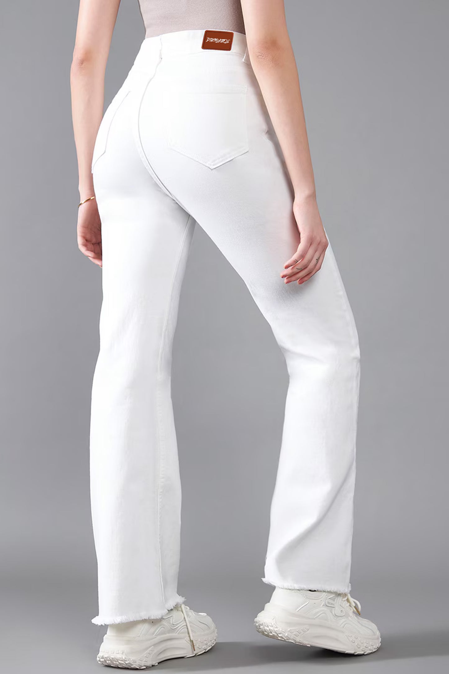 Back view of women's white bootcut jeans by Dirtylabels with a flattering fit for everyday wear