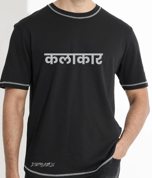 Black artistic graphic tee for men featuring the word 'कलाकार' in bold letters