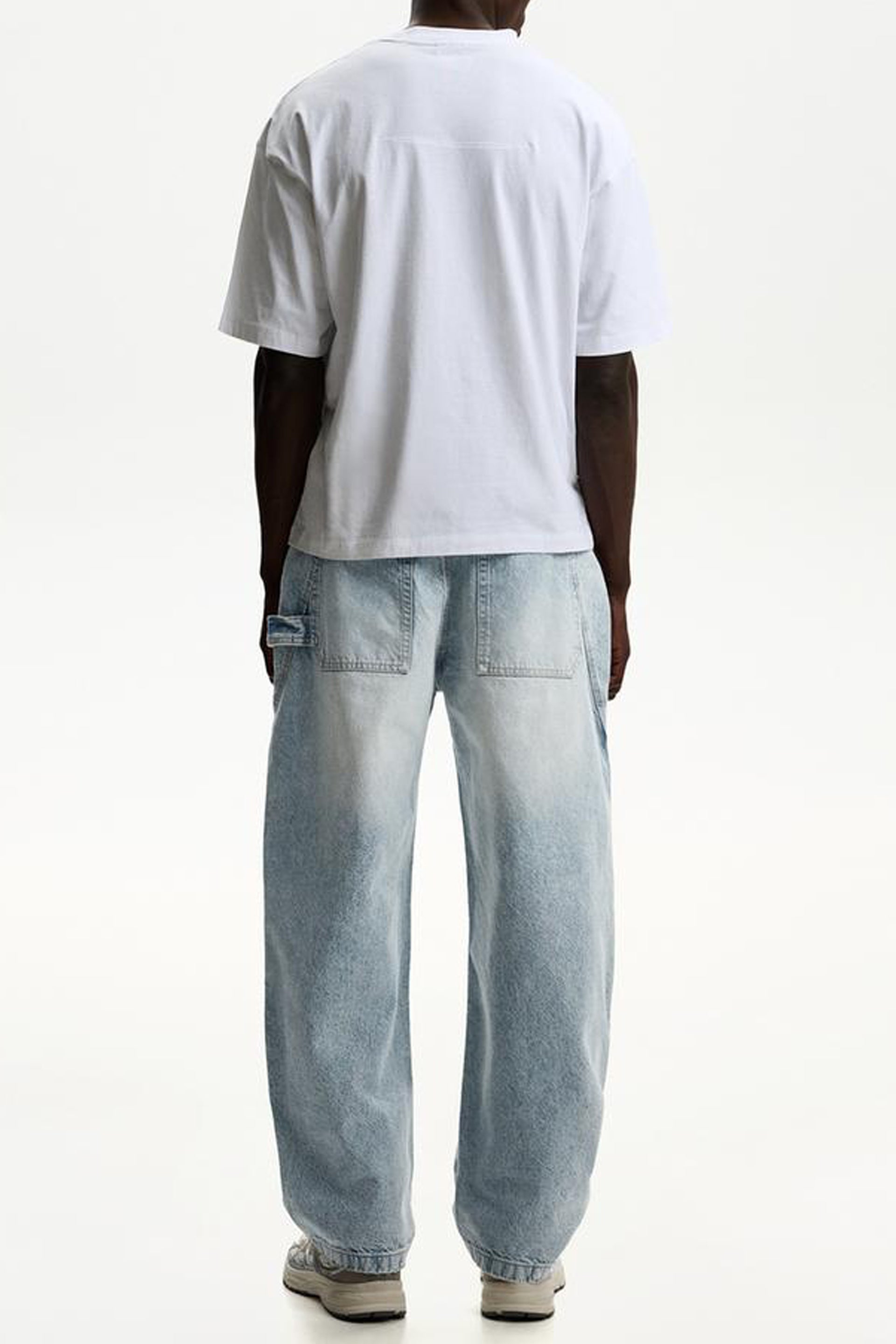 Casual outfit featuring balloon fit baggy jeans with a white t-shirt, shown from the back