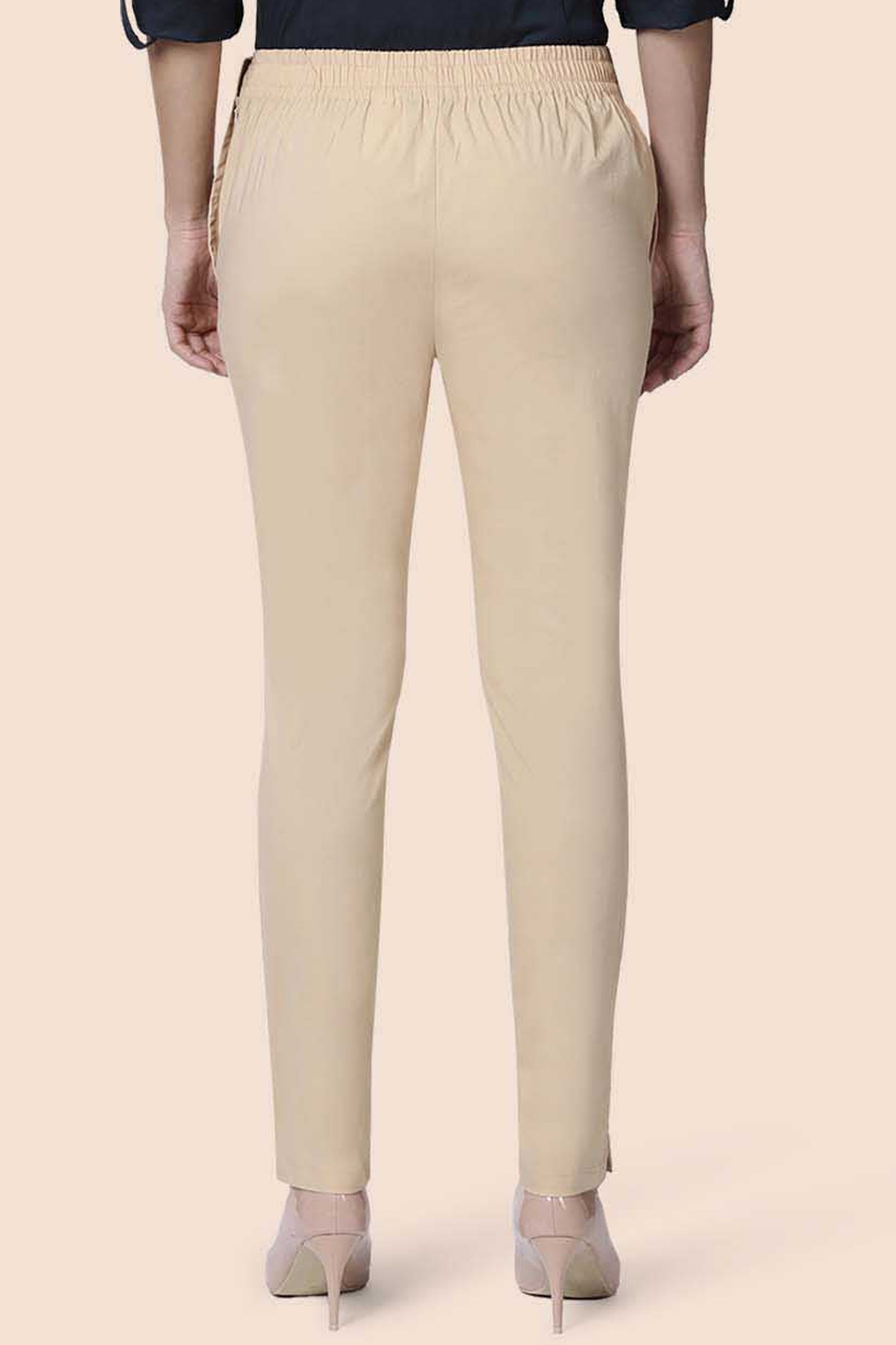Back view of beige straight pants for women with an elastic waistband for comfort and style