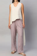 Beige summer top for women with a relaxed fit, paired with light pants and sandals for a casual look
