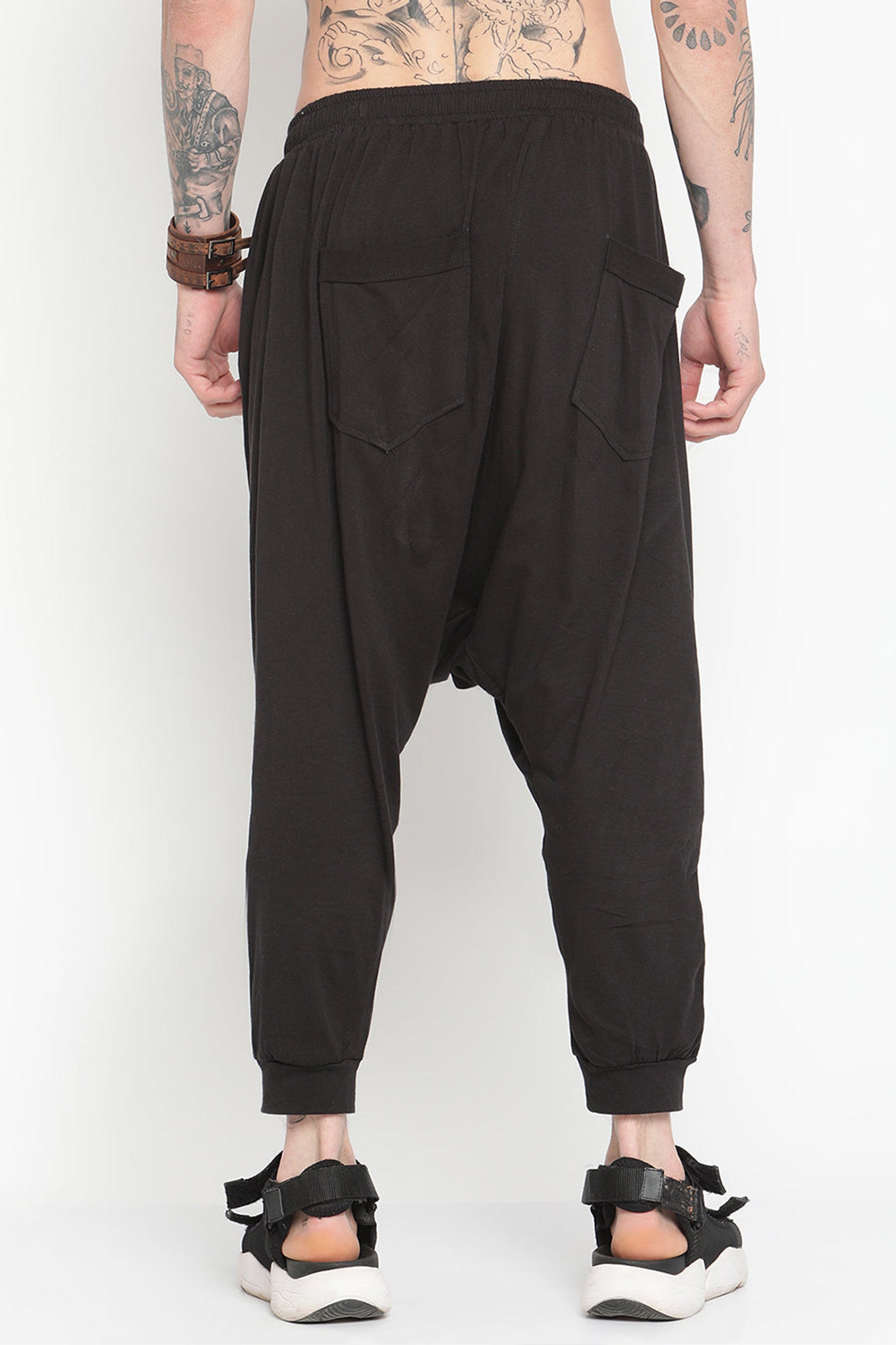 Men's black drop crotch harem pants with two back pockets for a stylish, relaxed fit