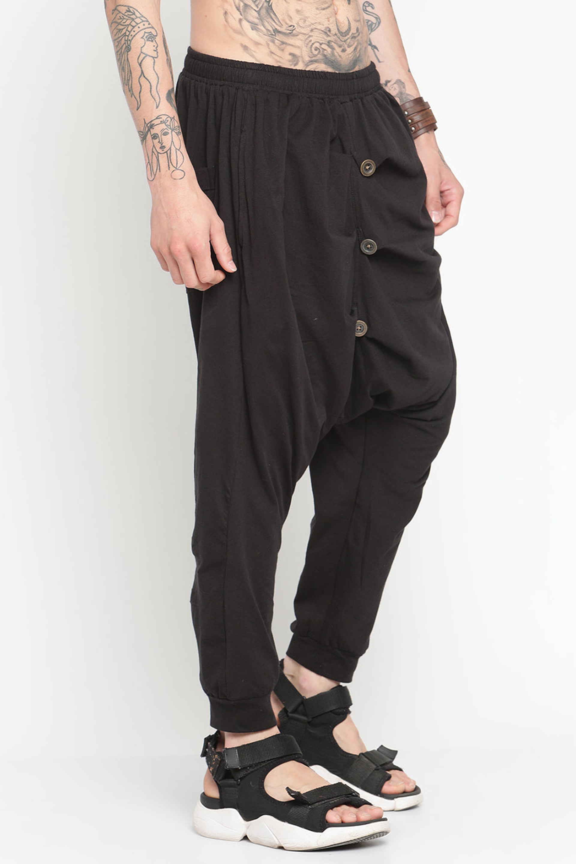 Black drop crotch harem pants with button details for a stylish and comfortable fit