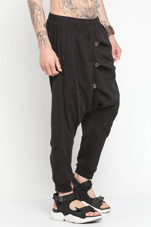Black drop crotch harem pants with button details for a stylish and comfortable fit
