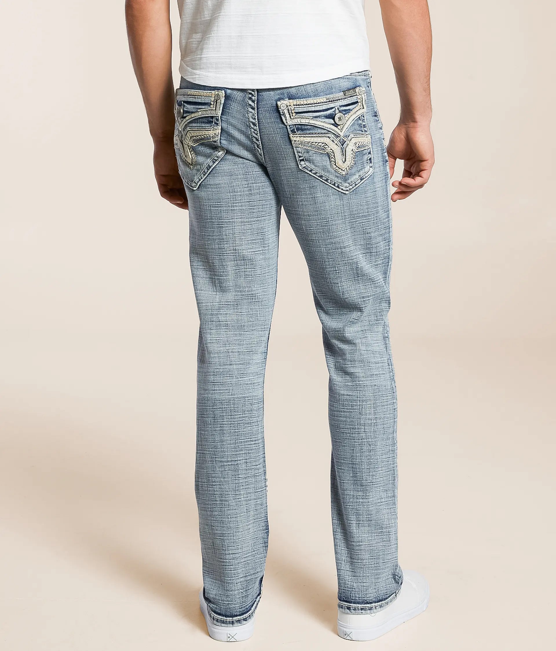 Men wearing light blue Tapered Stretch Jeans for Men with embroidered back pockets and a slim fit.