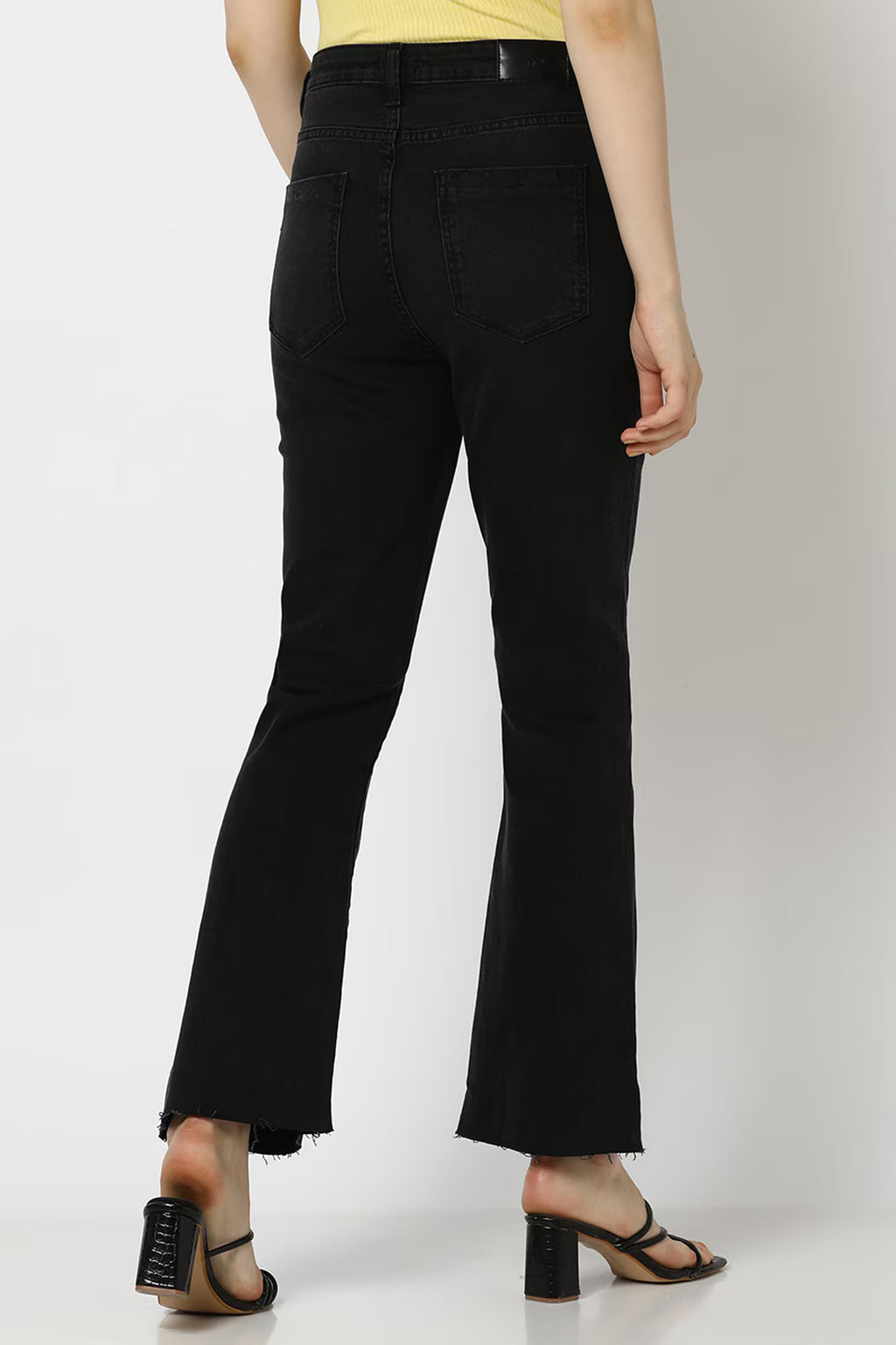 Black bootcut jeans with a frayed hem, perfect for casual wear. Buy bootcut jeans online India.