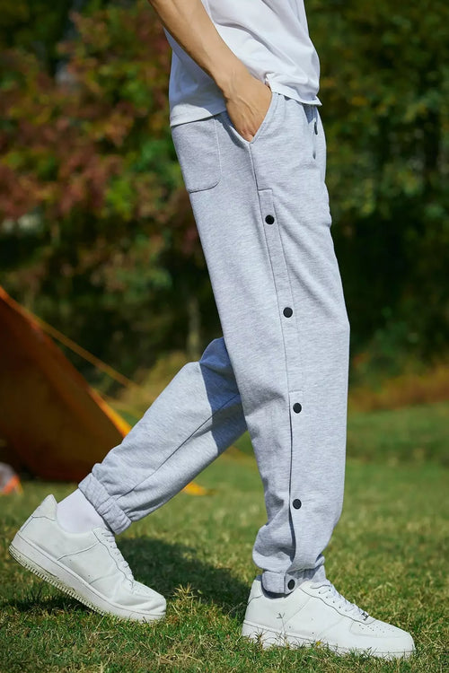 Men wearing gray retro joggers with button details for casual style. Buy retro joggers for men.