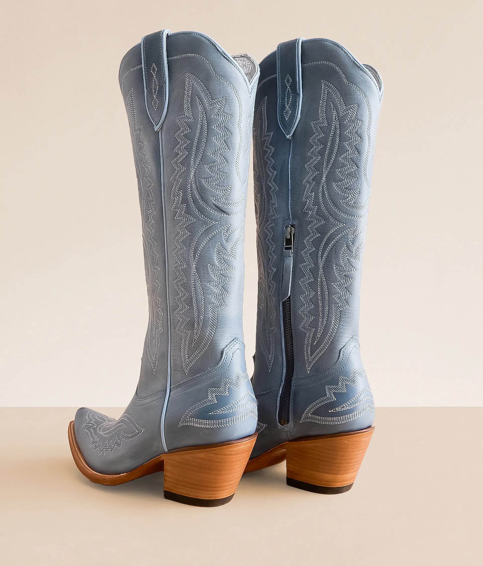 Light blue Casanova leather boots with intricate stitching and a stylish heel