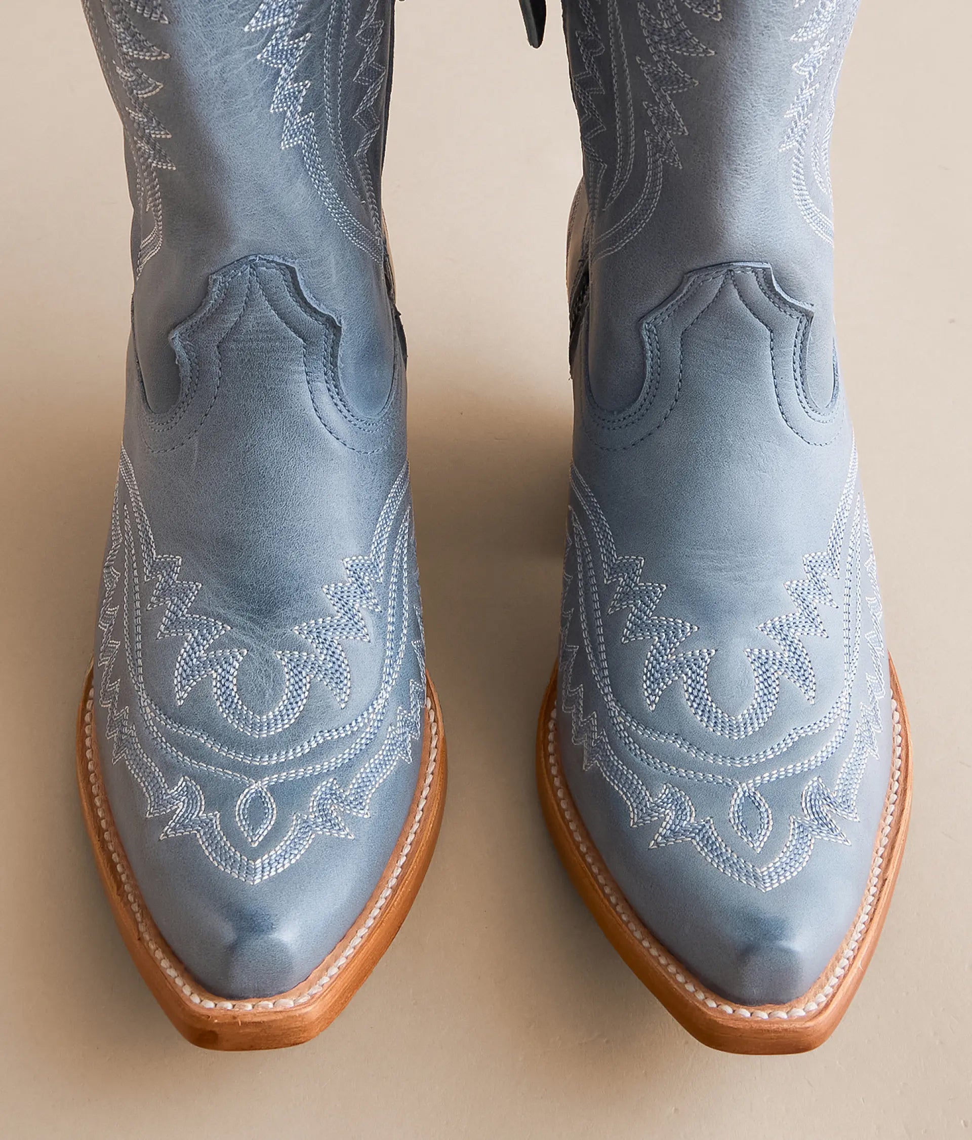Casanova leather boots in light blue with intricate stitching and pointed toe design