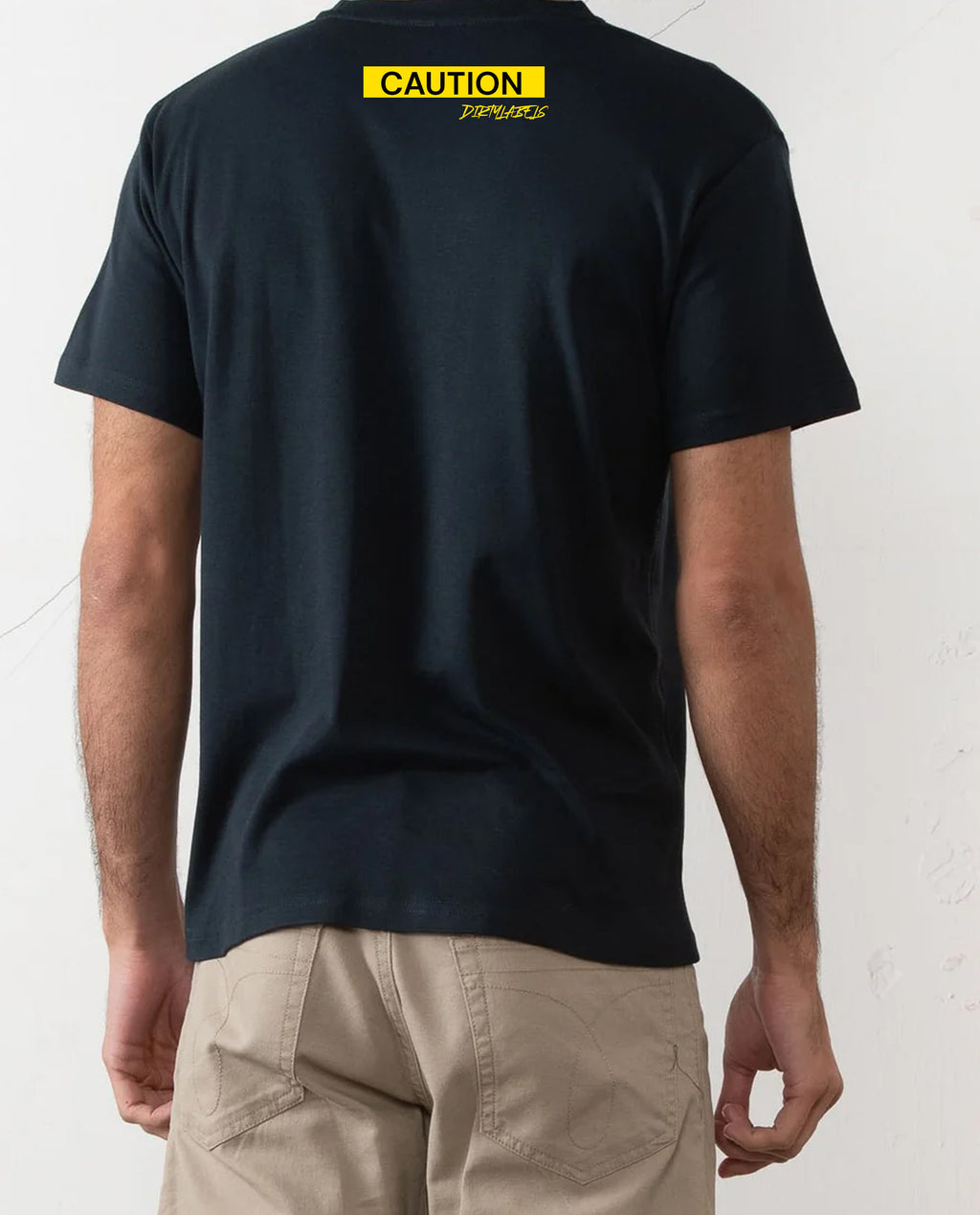 Back view of a casual black tee for men featuring a bold yellow caution graphic