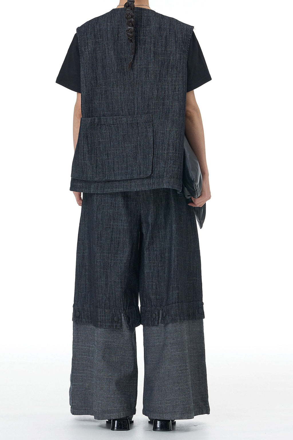 Back view of a dirtylabels denim waistcoat co-ord set featuring a relaxed fit and wide-leg trousers