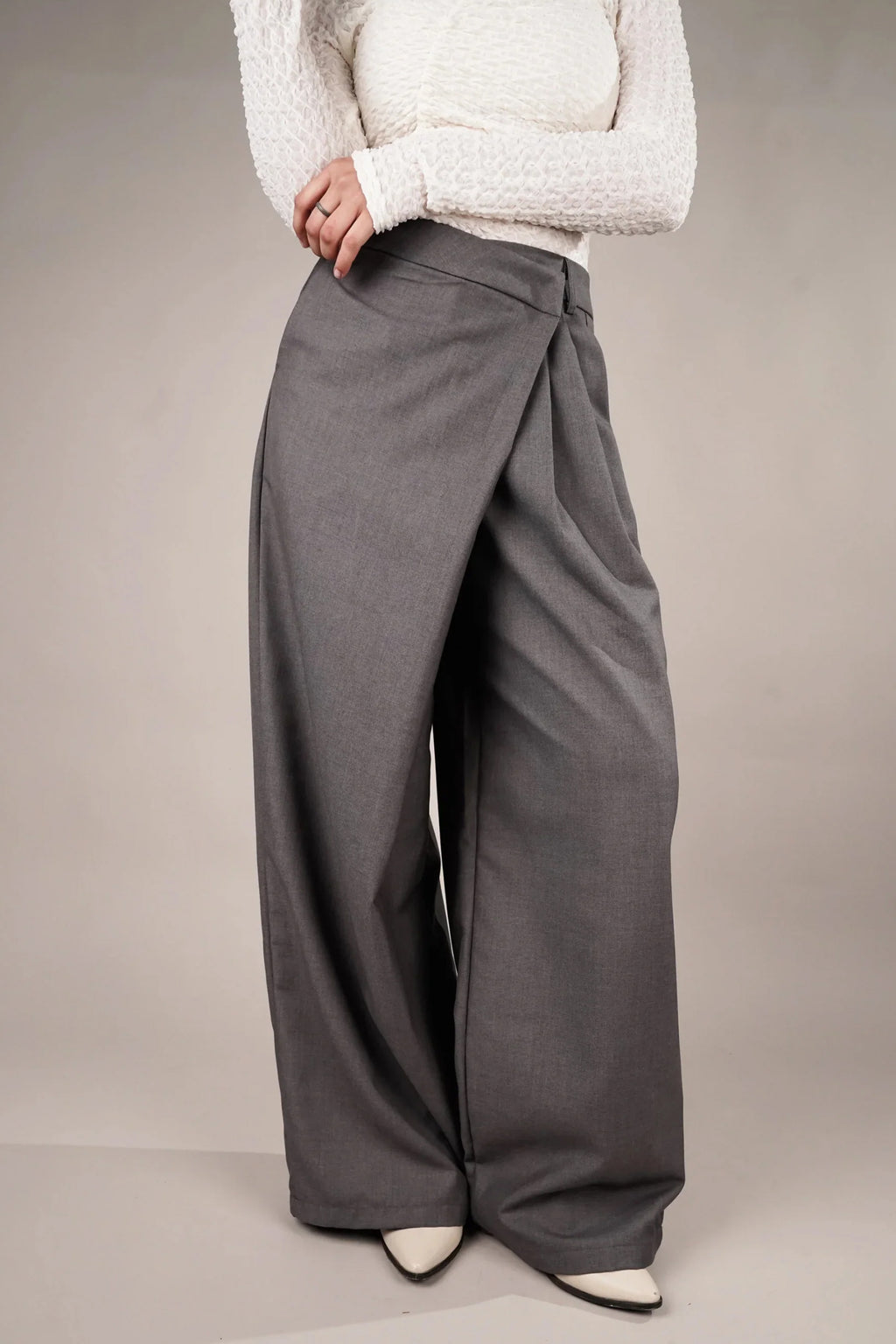 Stylish draped asymmetrical pants online in gray, featuring a relaxed fit and unique design