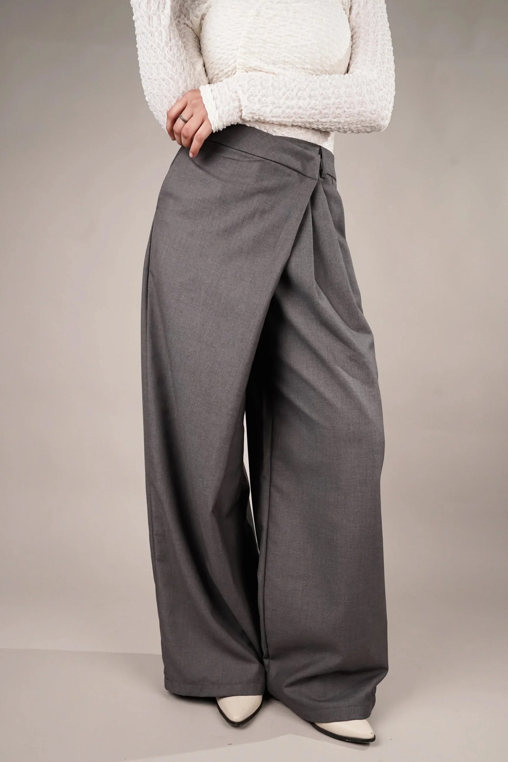 Stylish draped asymmetrical pants online in gray, featuring a relaxed fit and unique design