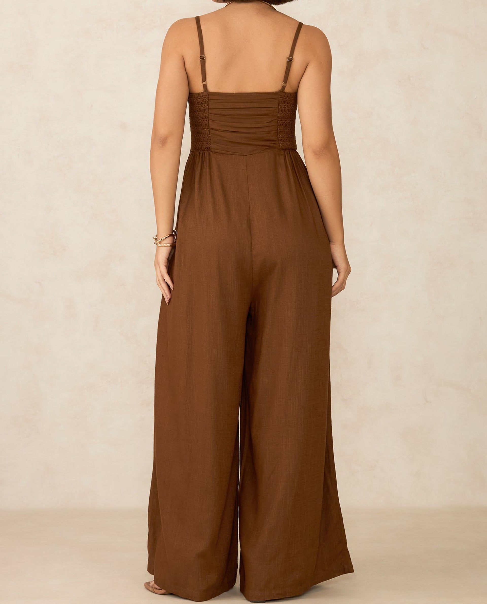 Back view of a brown elegant jumpsuit for parties with wide leg design and adjustable straps