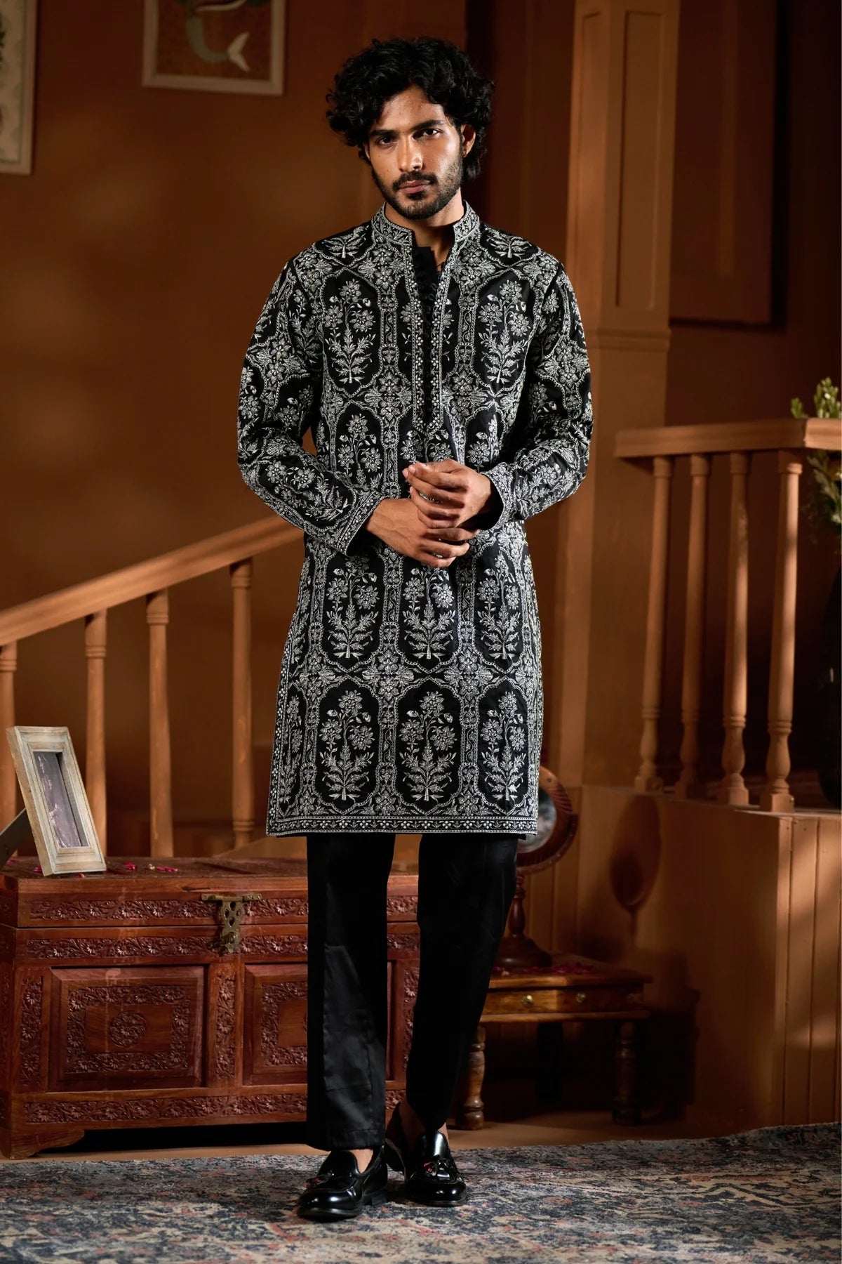Festive men's ethnic wear set in black with intricate patterns, perfect for celebrations