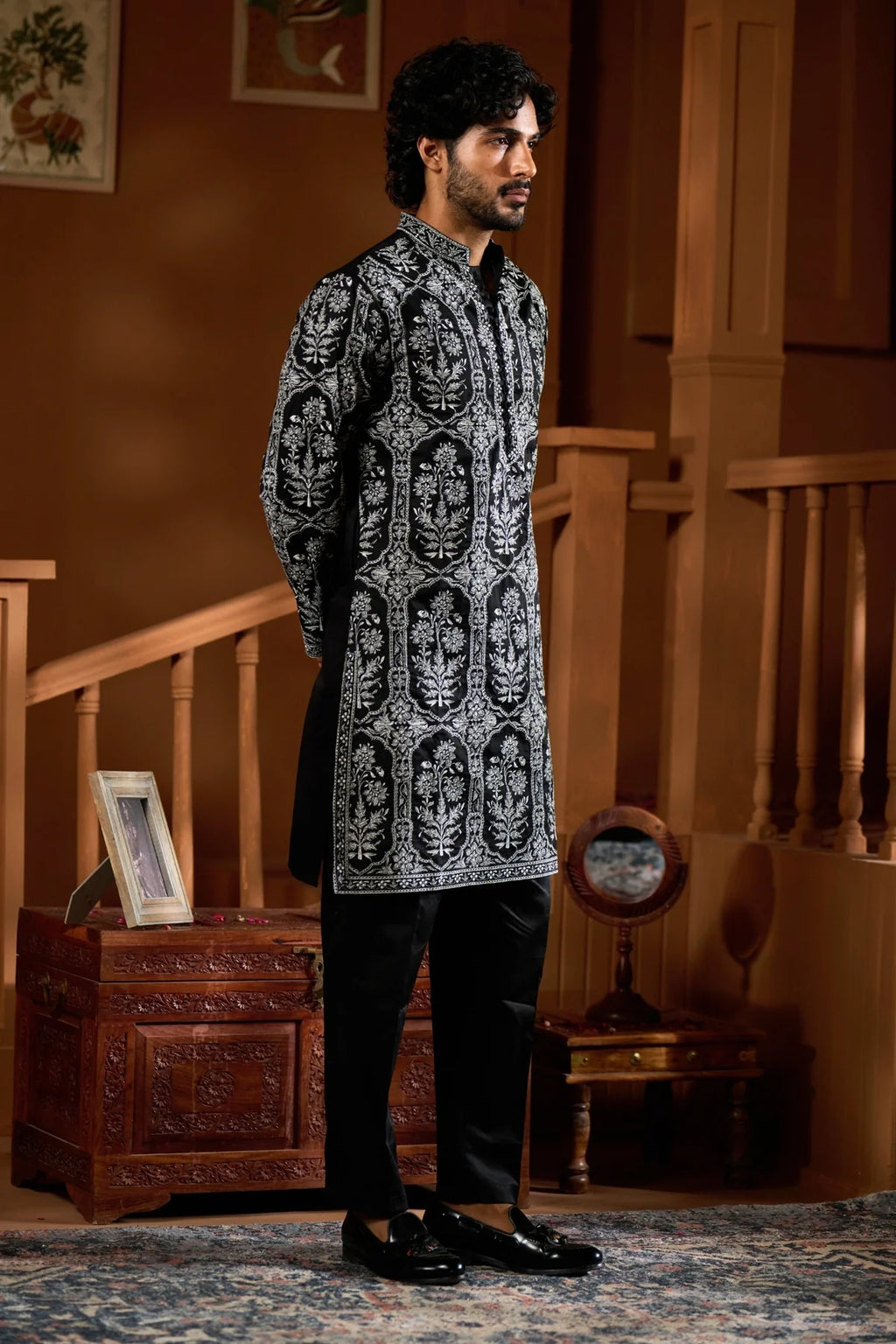 Elegant festive men's ethnic wear set featuring a black patterned kurta and matching trousers