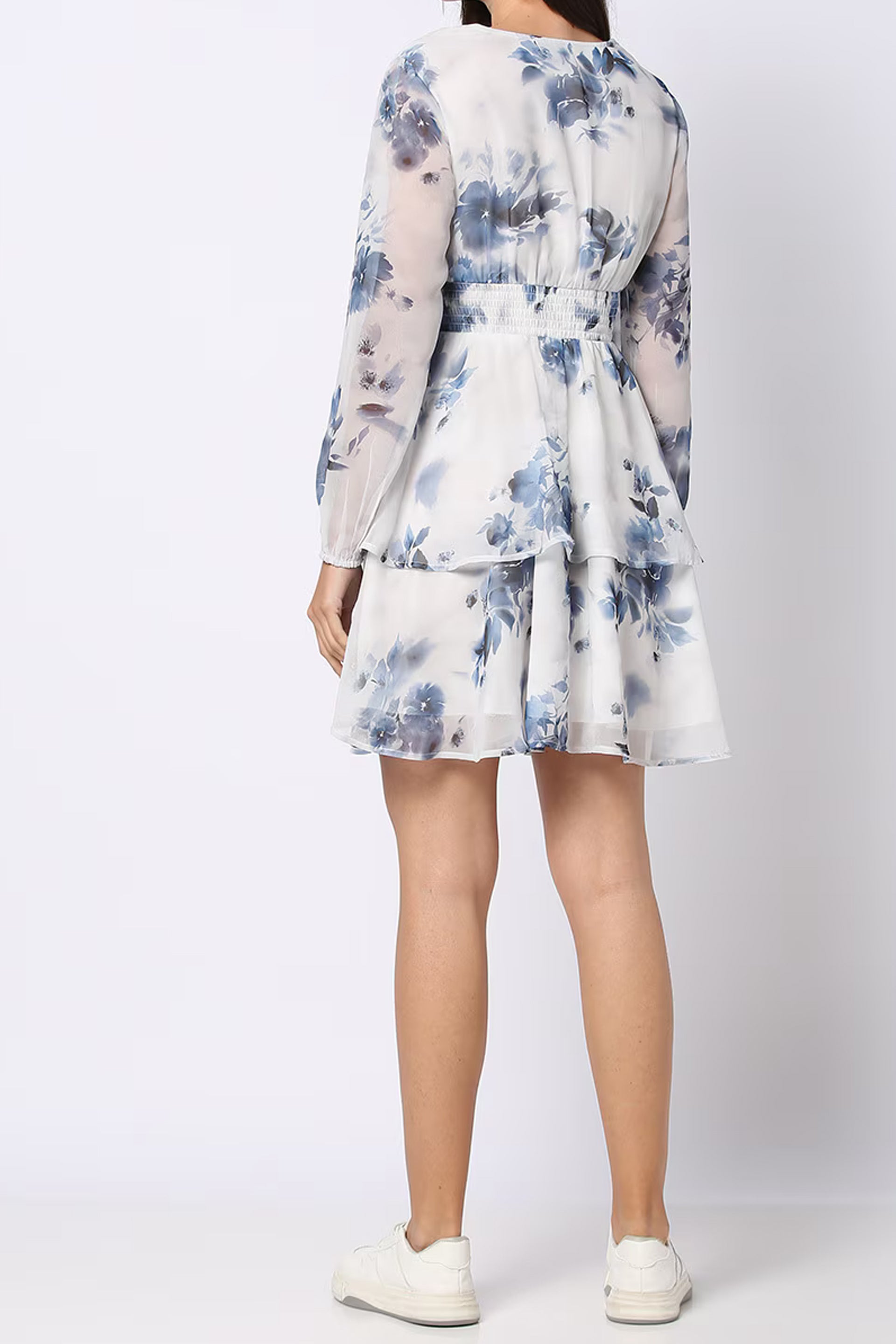 Back view of a Floral Fit and Flare Dress with tiered ruffles in soft blue floral print