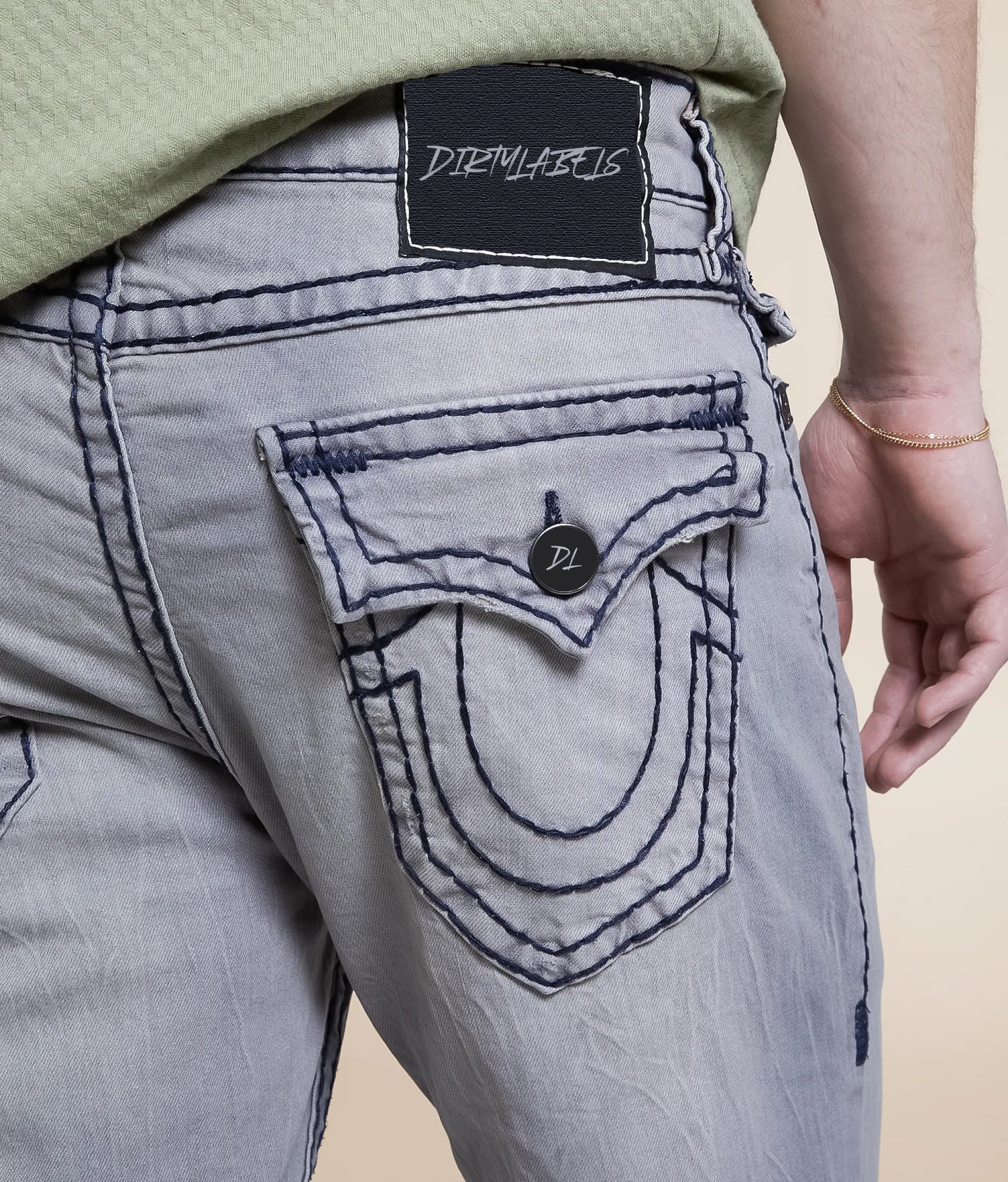 Back view of Dirtylabels Grey Relaxed Skinny Jeans featuring unique pocket design and stitching details