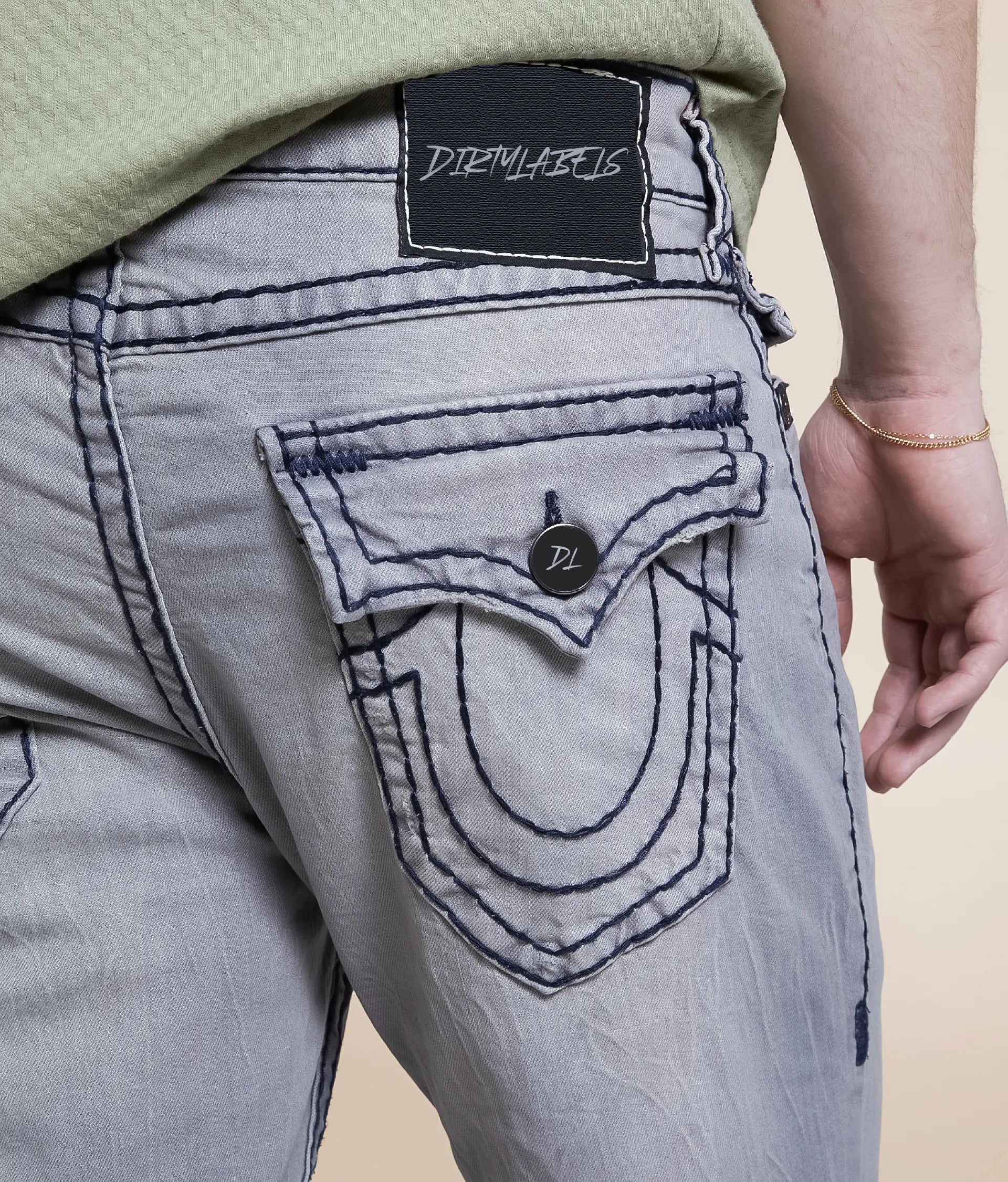Back view of Dirtylabels Grey Relaxed Skinny Jeans featuring unique pocket design and stitching details