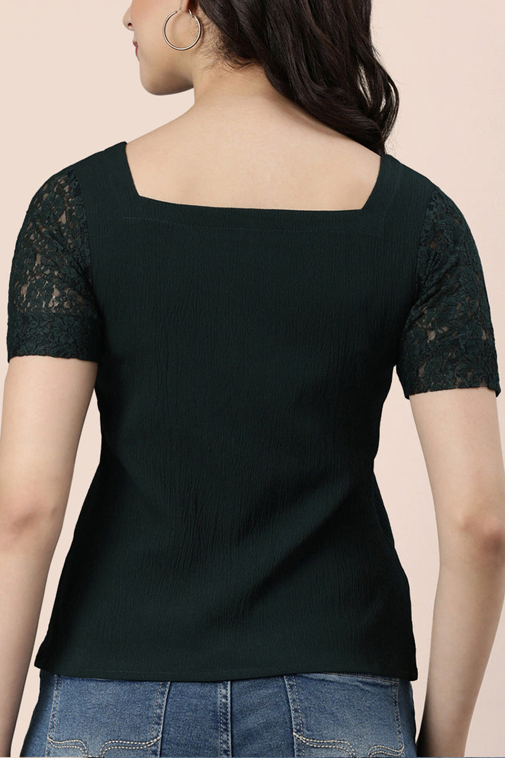 Back view of a dark green Indian fashion lace blouse with short lace sleeves