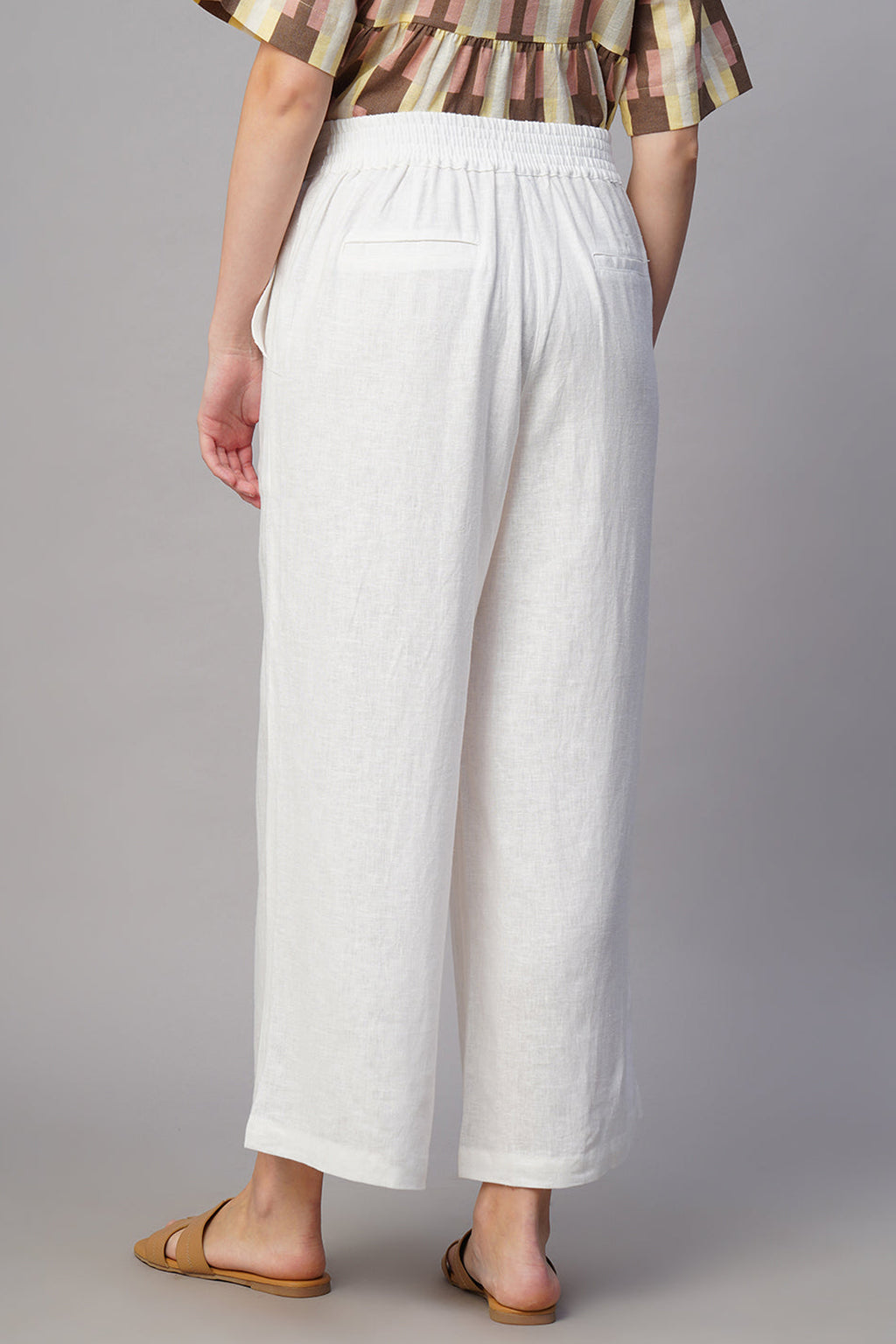 Back view of white linen viscose culottes for women with elastic waistband and pockets