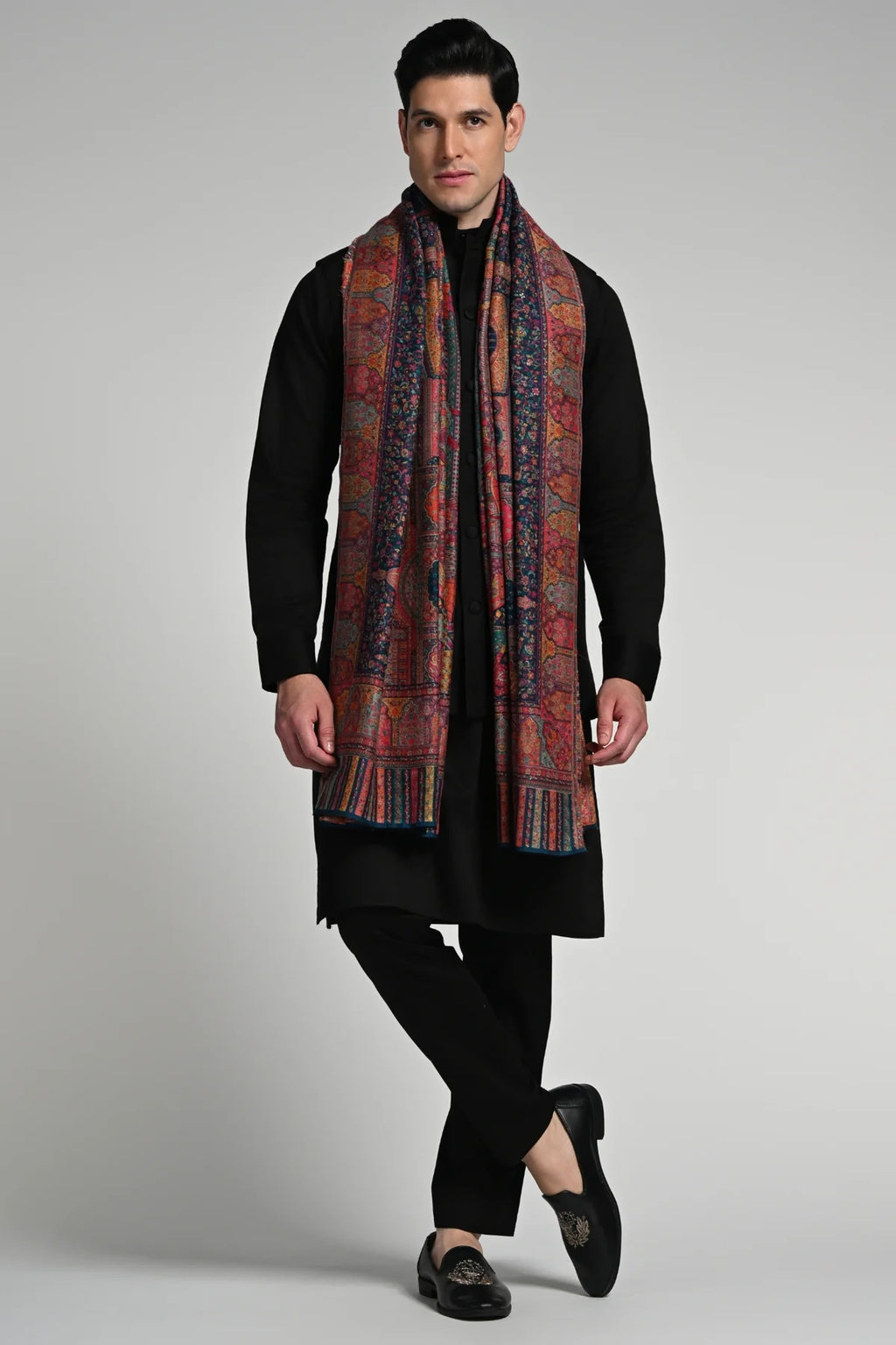 Elegant model wearing a luxury ethnic shawl for winter, showcasing intricate patterns and rich colors.
