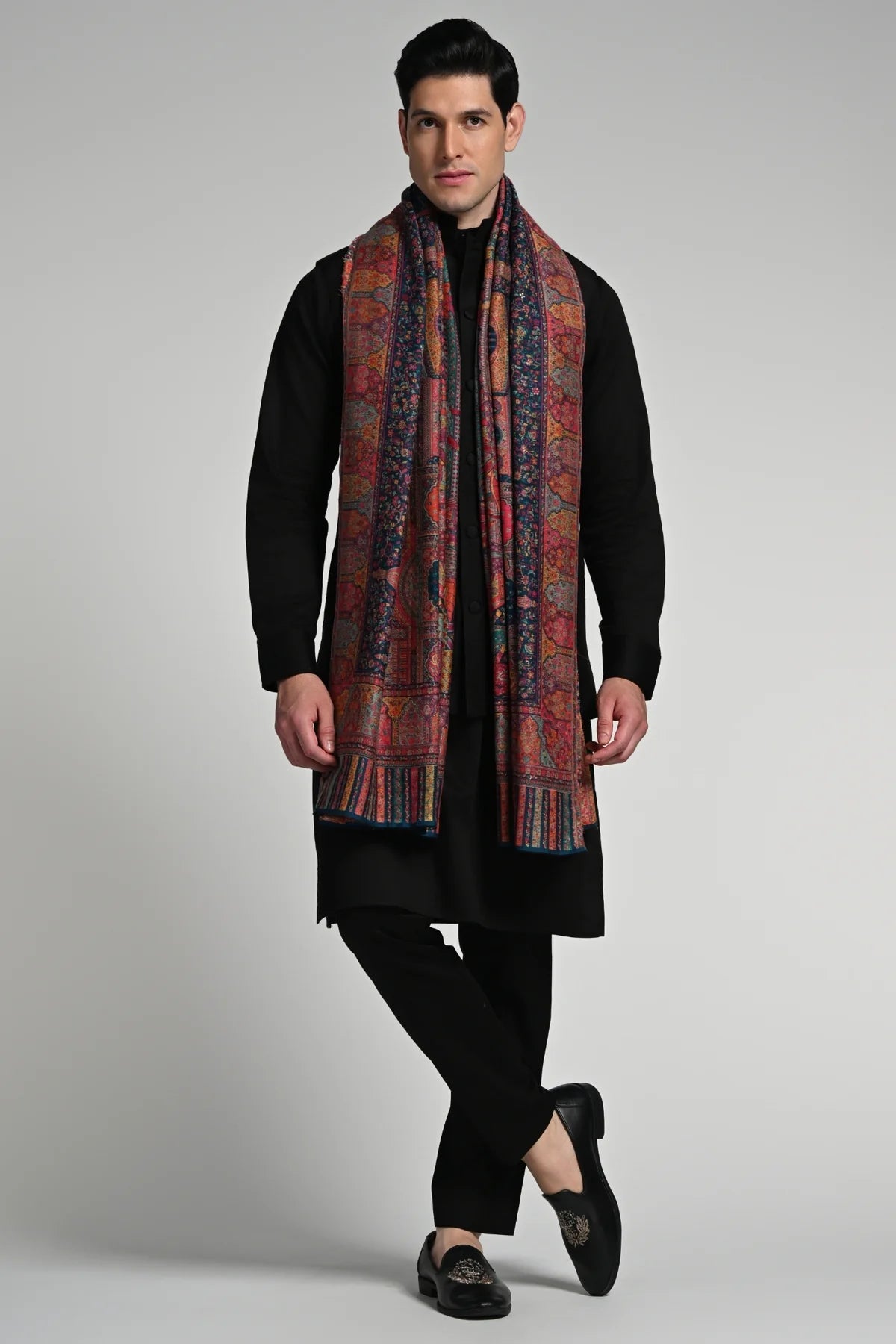 Elegant model wearing a luxury ethnic shawl for winter, showcasing intricate patterns and rich colors.
