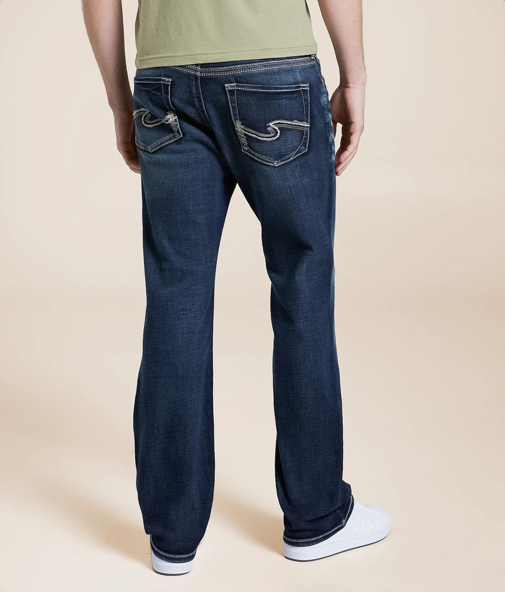 Back view of men's slim bootcut jeans in dark blue with stylish stitching and pockets