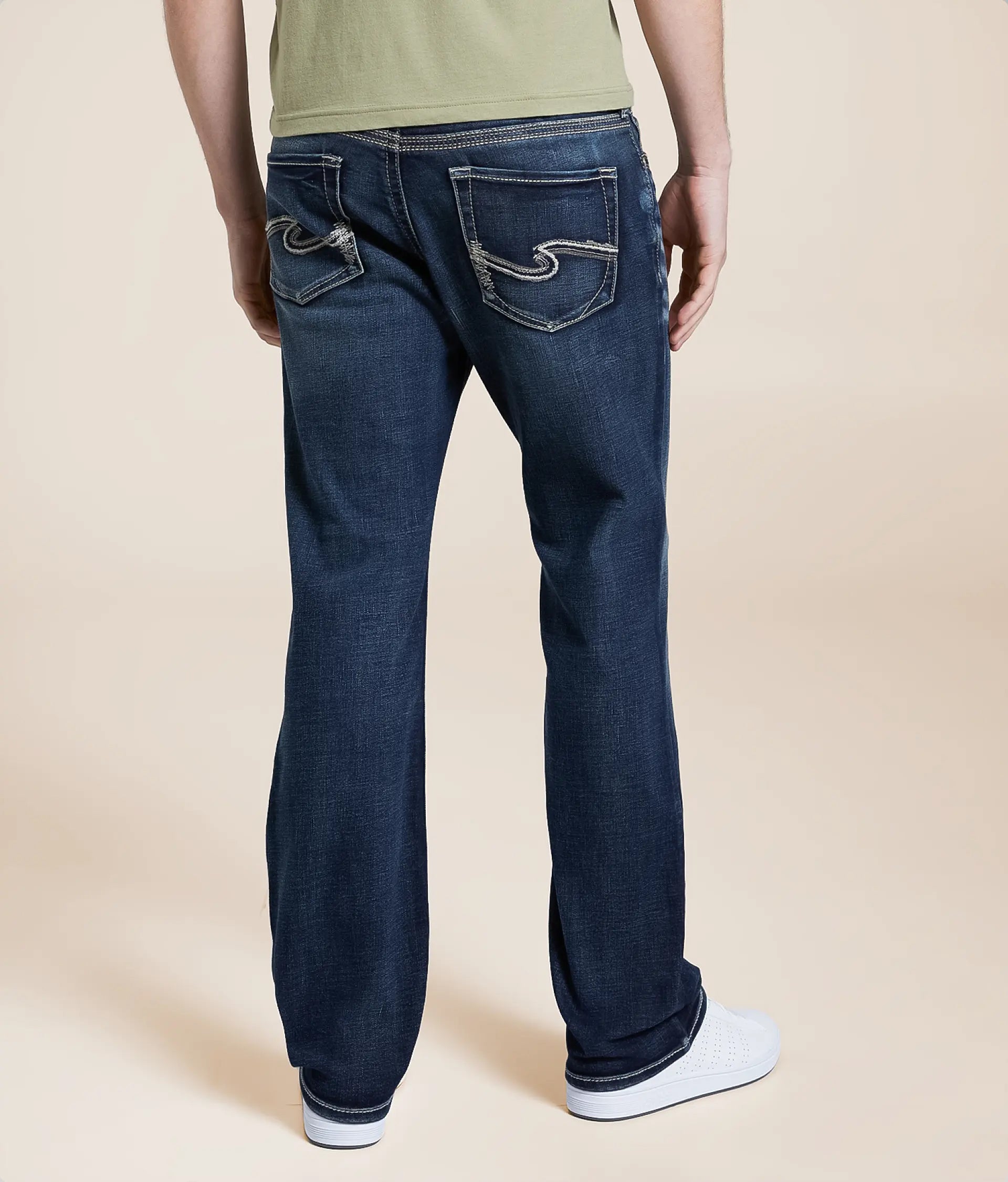 Back view of men's slim bootcut jeans in dark blue with stylish stitching and pockets