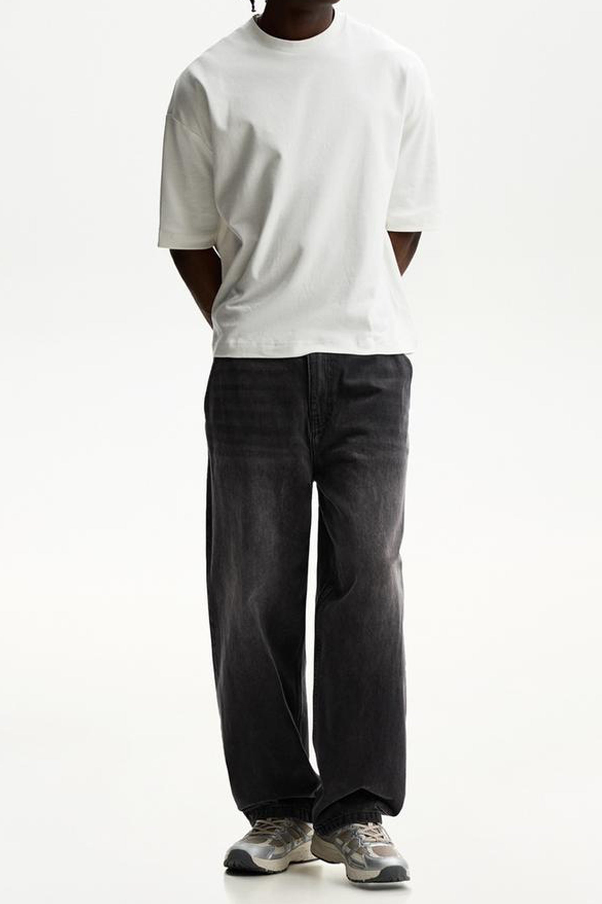 Stylish men's skater jeans India in dark wash, paired with a white t-shirt for a trendy casual look