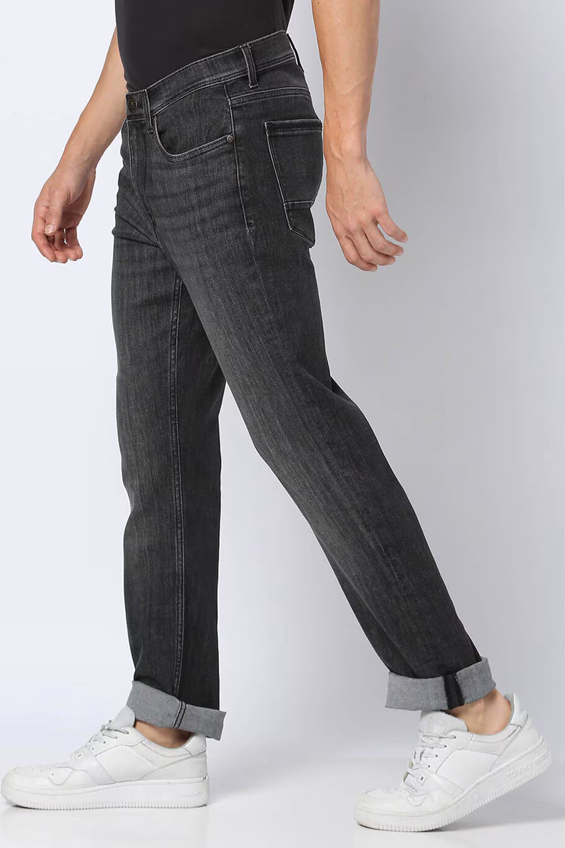 Men's straight jeans India in dark gray with rolled cuffs and a side view showcasing a comfortable fit