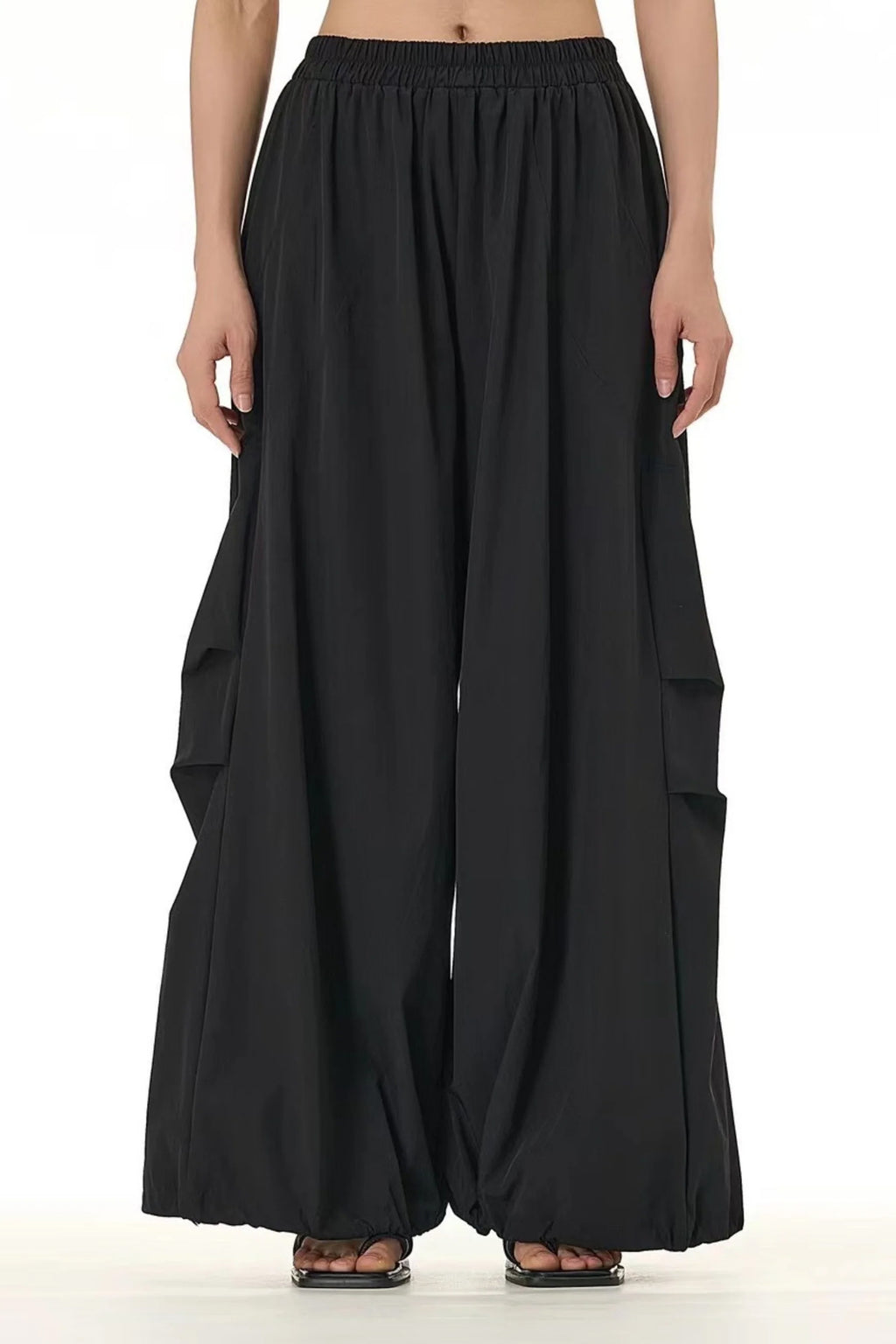 Flowy modern black trousers for women featuring a high waist and wide leg design