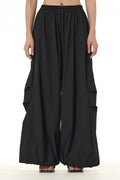 Flowy modern black trousers for women featuring a high waist and wide leg design