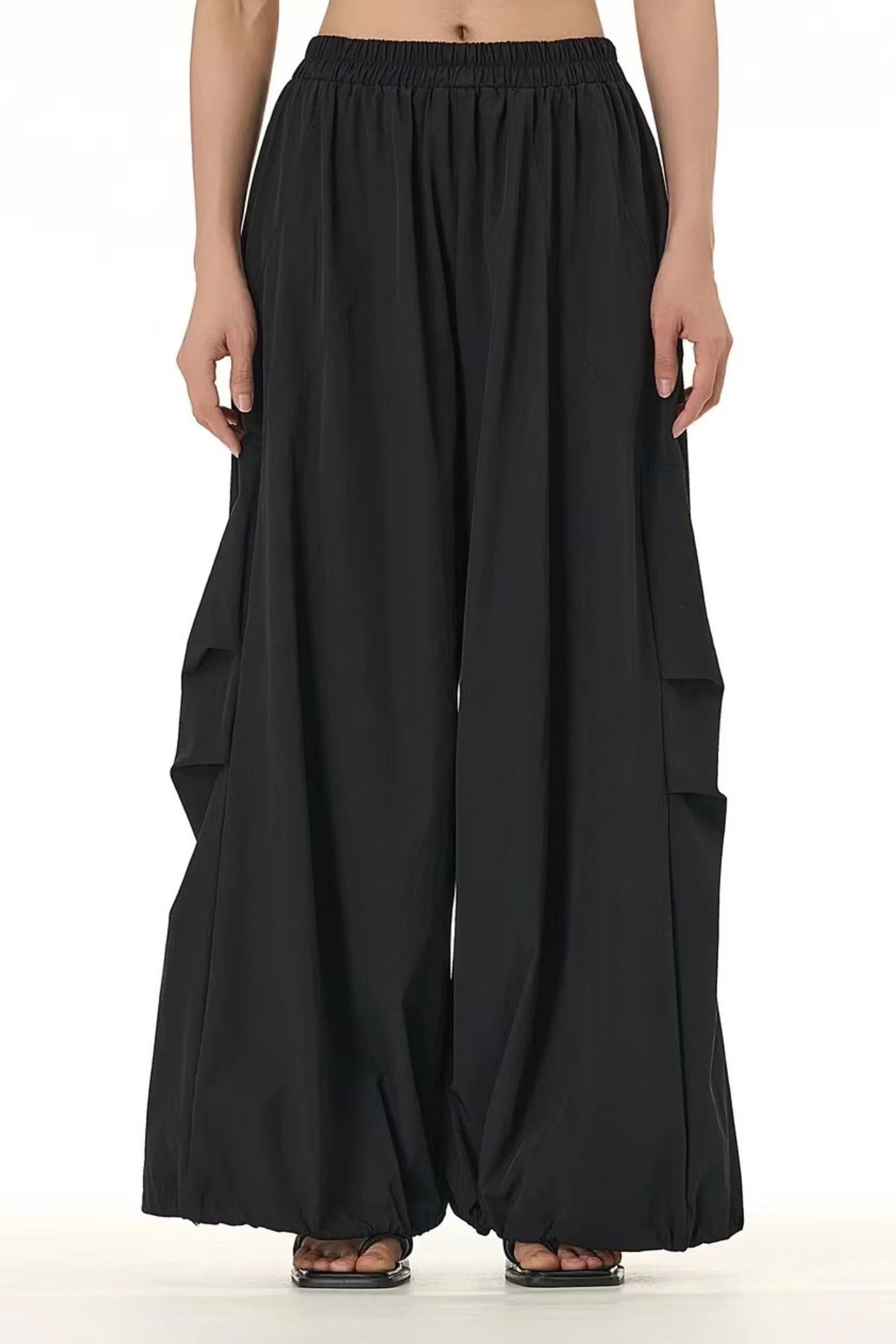 Flowy modern black trousers for women featuring a high waist and wide leg design