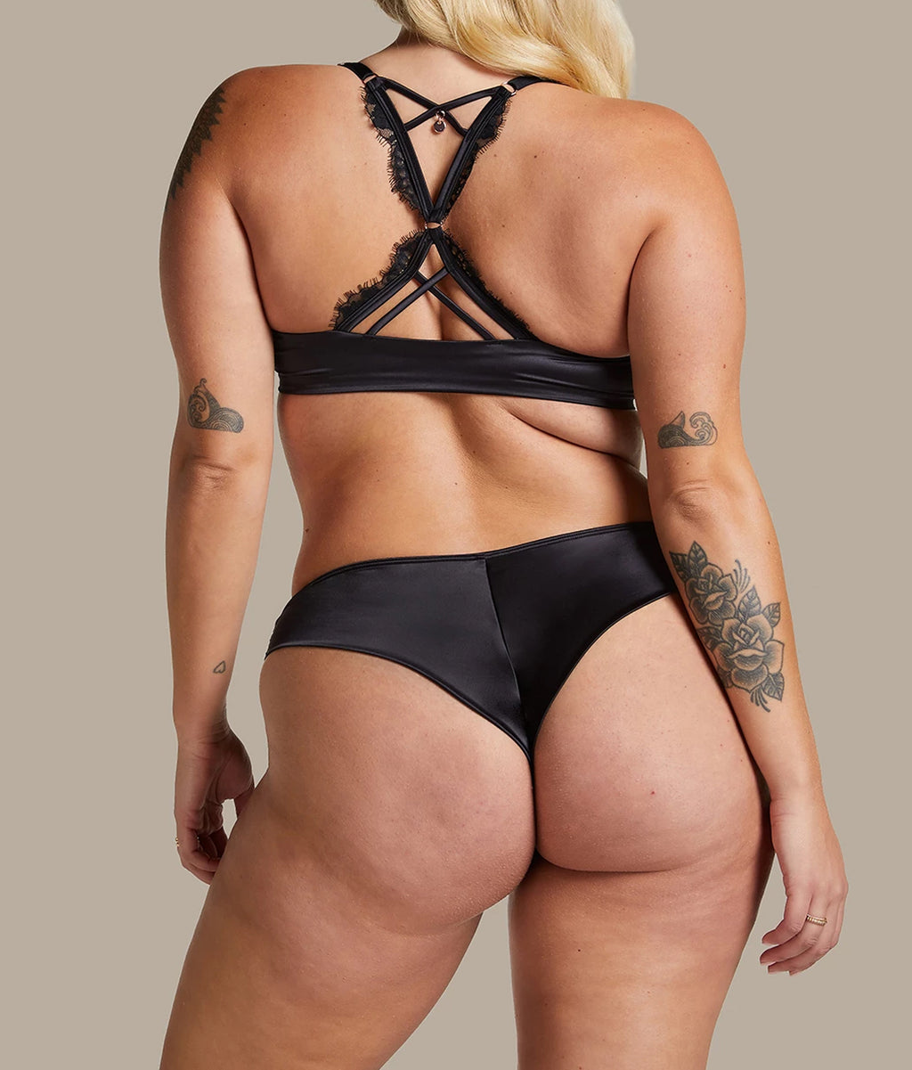 Elegant black padded push-up bra India with intricate lace detailing and stylish crossover straps