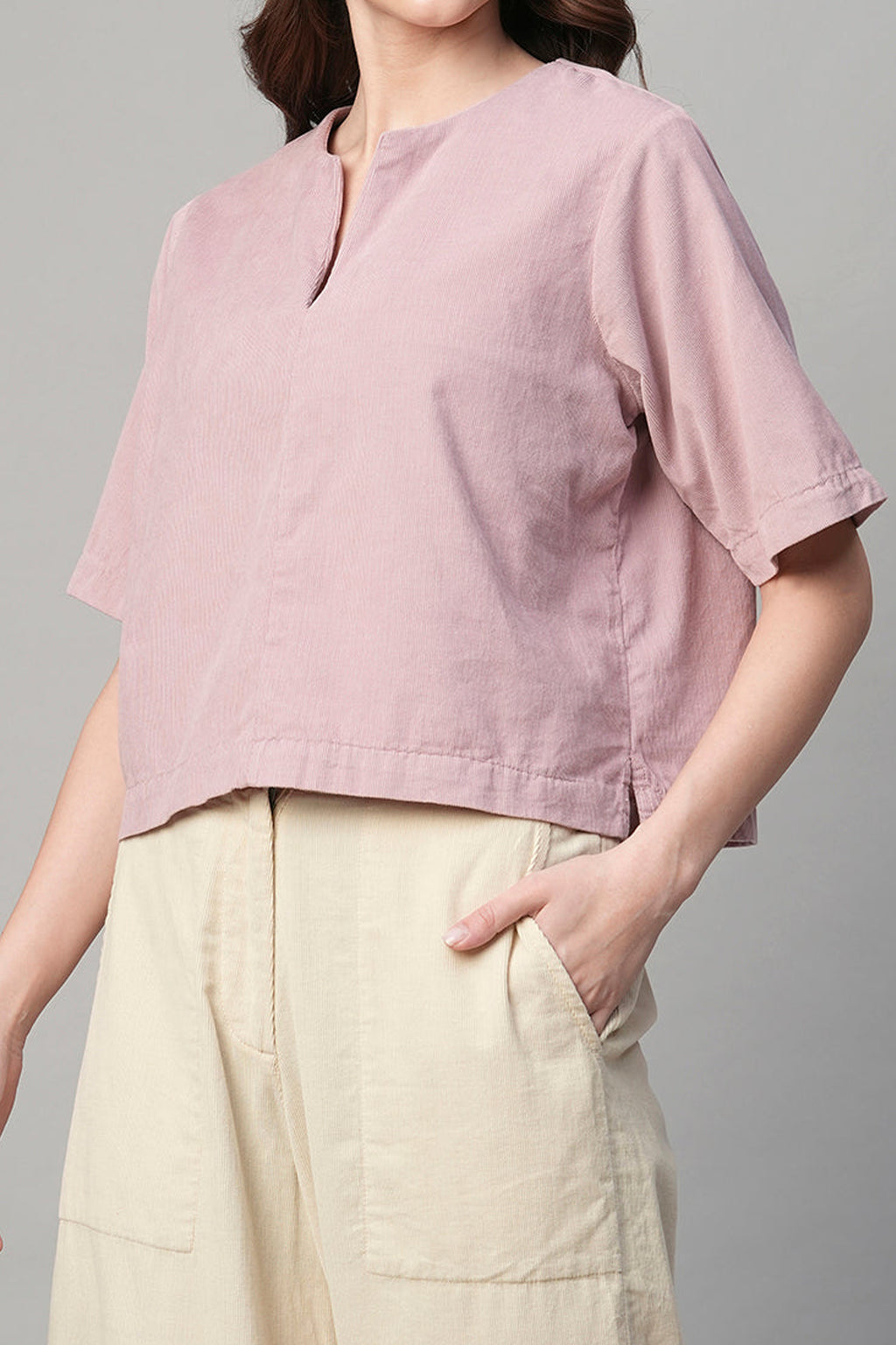 Fashionable pink corduroy shirt women with short sleeves and a round neckline