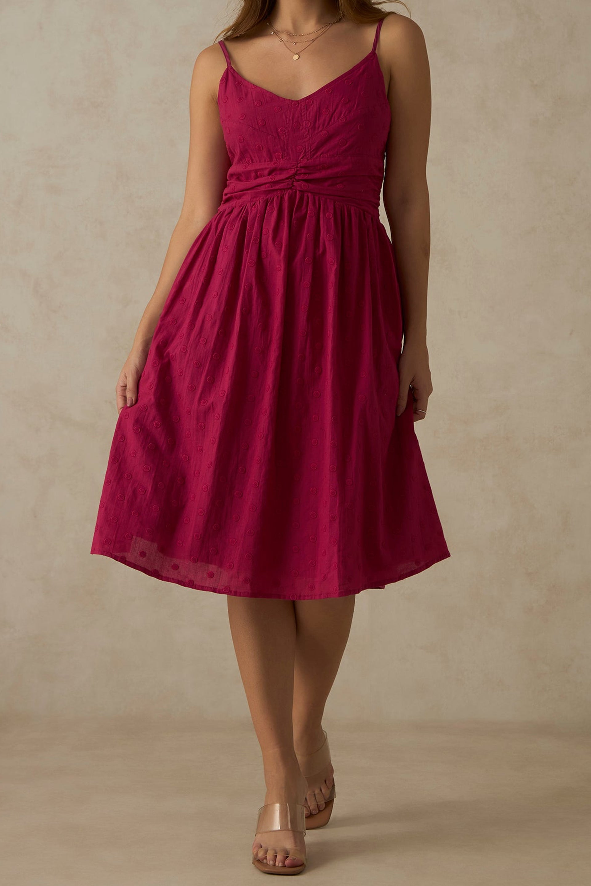 Elegant pink ruched midi dress with adjustable straps, perfect for summer outings and special occasions.