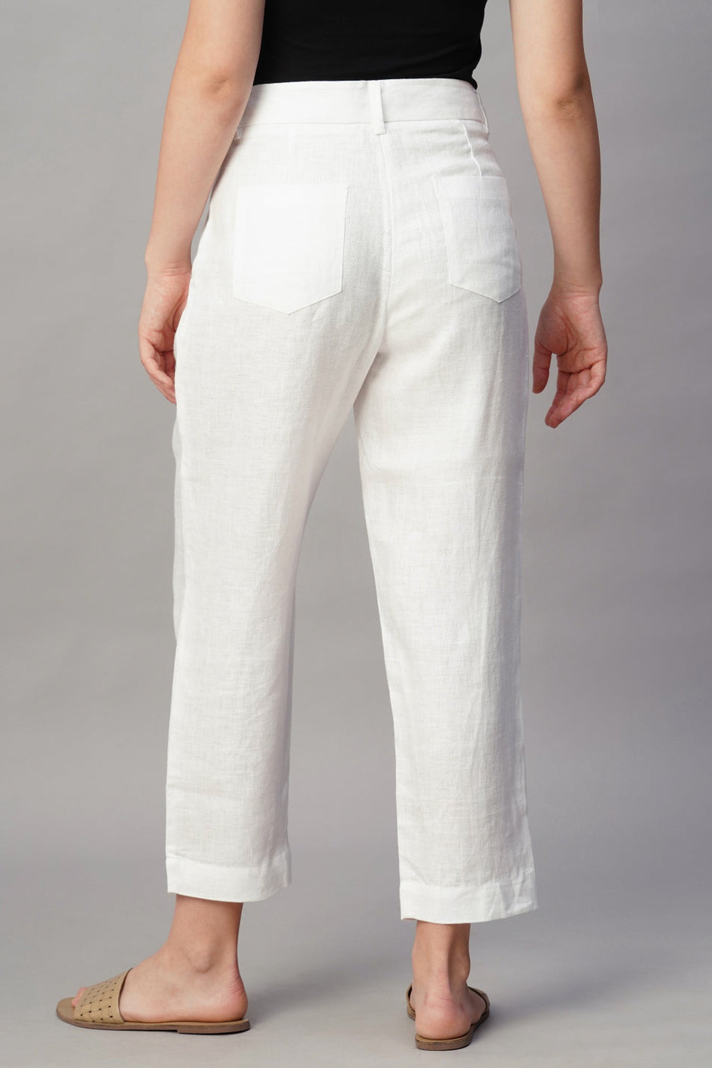 Back view of Dirtylabels regular fit linen trousers in white, showing pockets and comfortable design