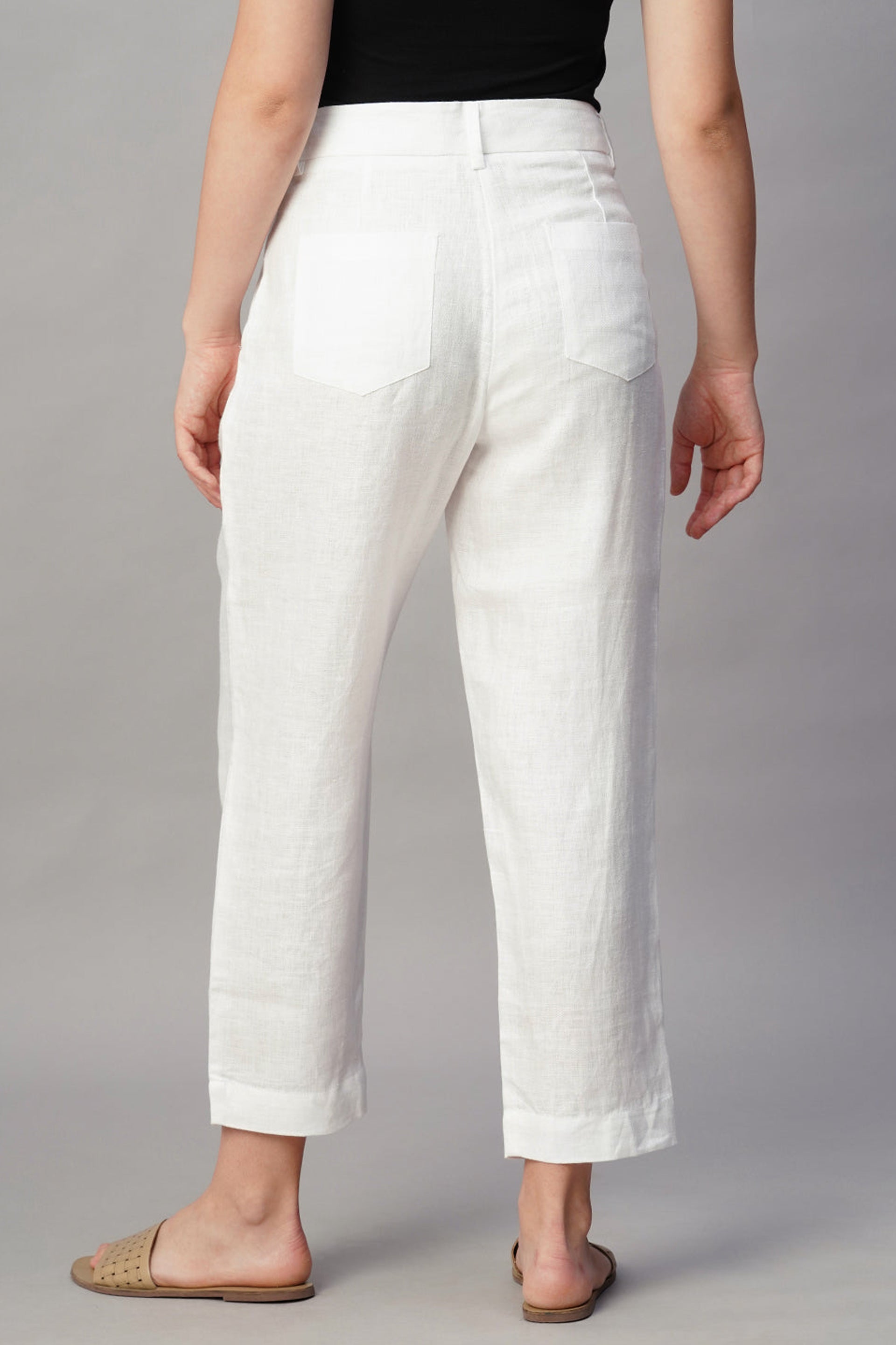 Back view of Dirtylabels regular fit linen trousers in white, showing pockets and comfortable design
