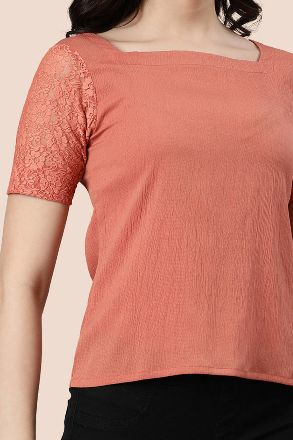 Rose gold lace top with soft fabric and delicate lace sleeves for a stylish look