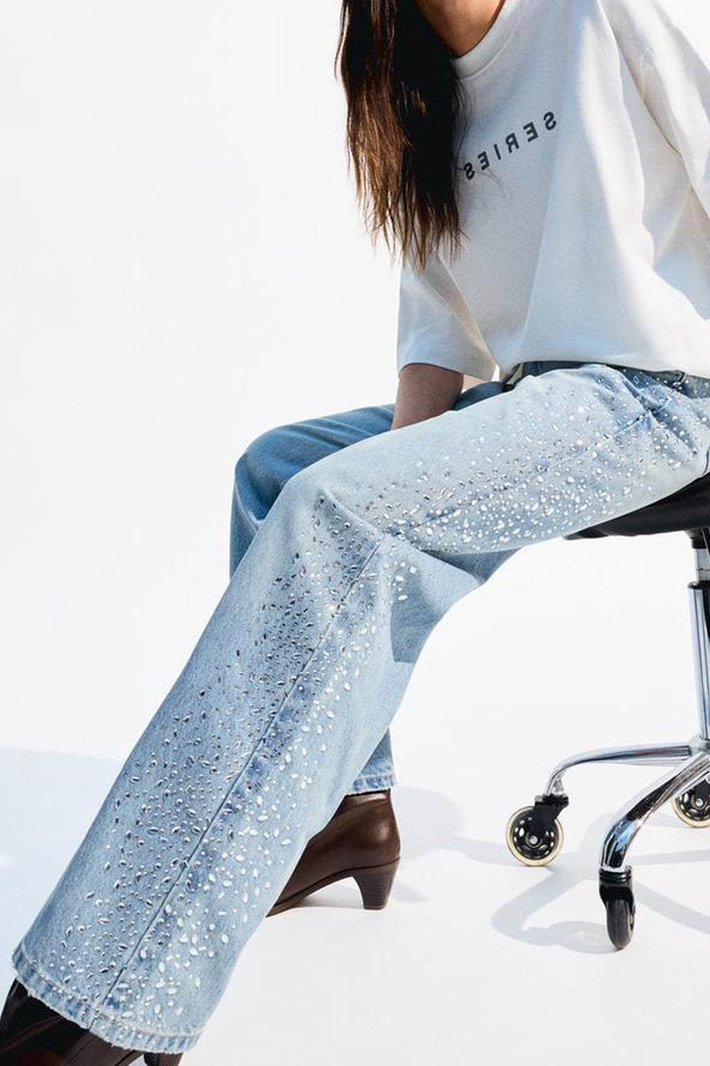 Trendy shimmery denim for women with sparkling embellishments, paired with a casual white top