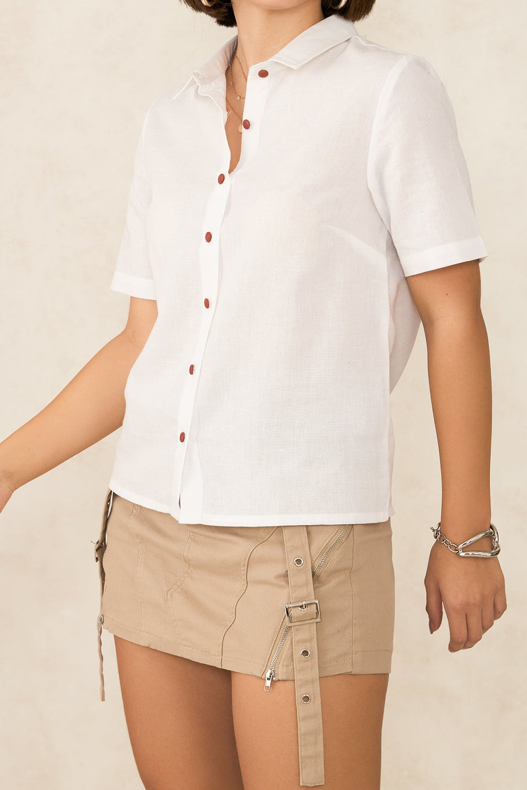White short sleeve button up shirt with brown button details, perfect for casual summer outfits