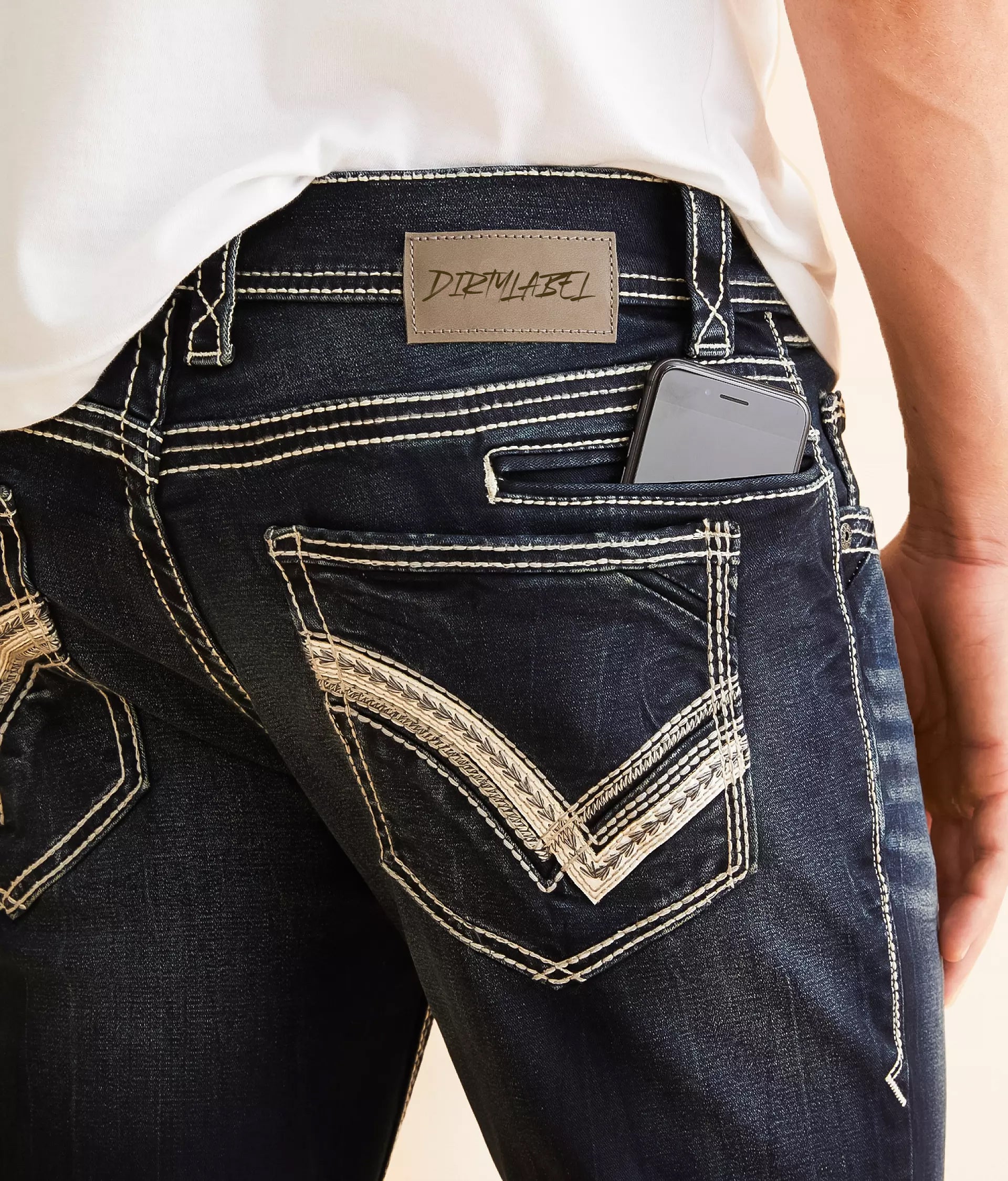 Close-up of dirtylabels stylish black jeans for men with unique stitching and phone in back pocket