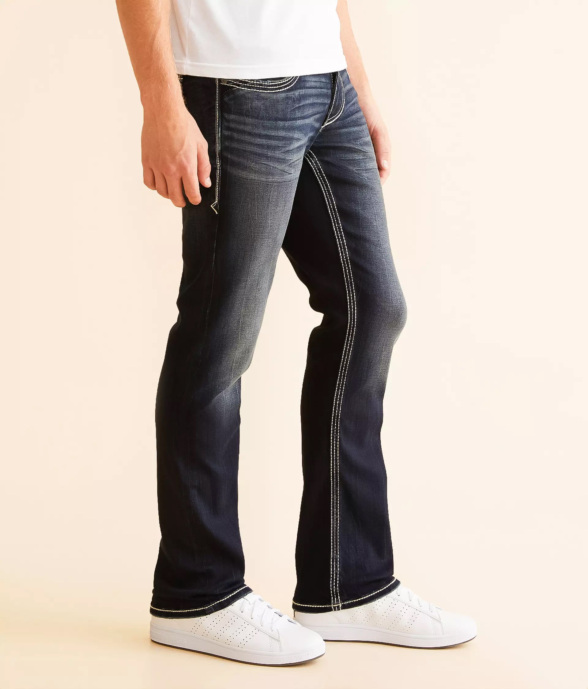 Stylish black jeans for men with a slim fit and contrasting stitching, paired with white sneakers