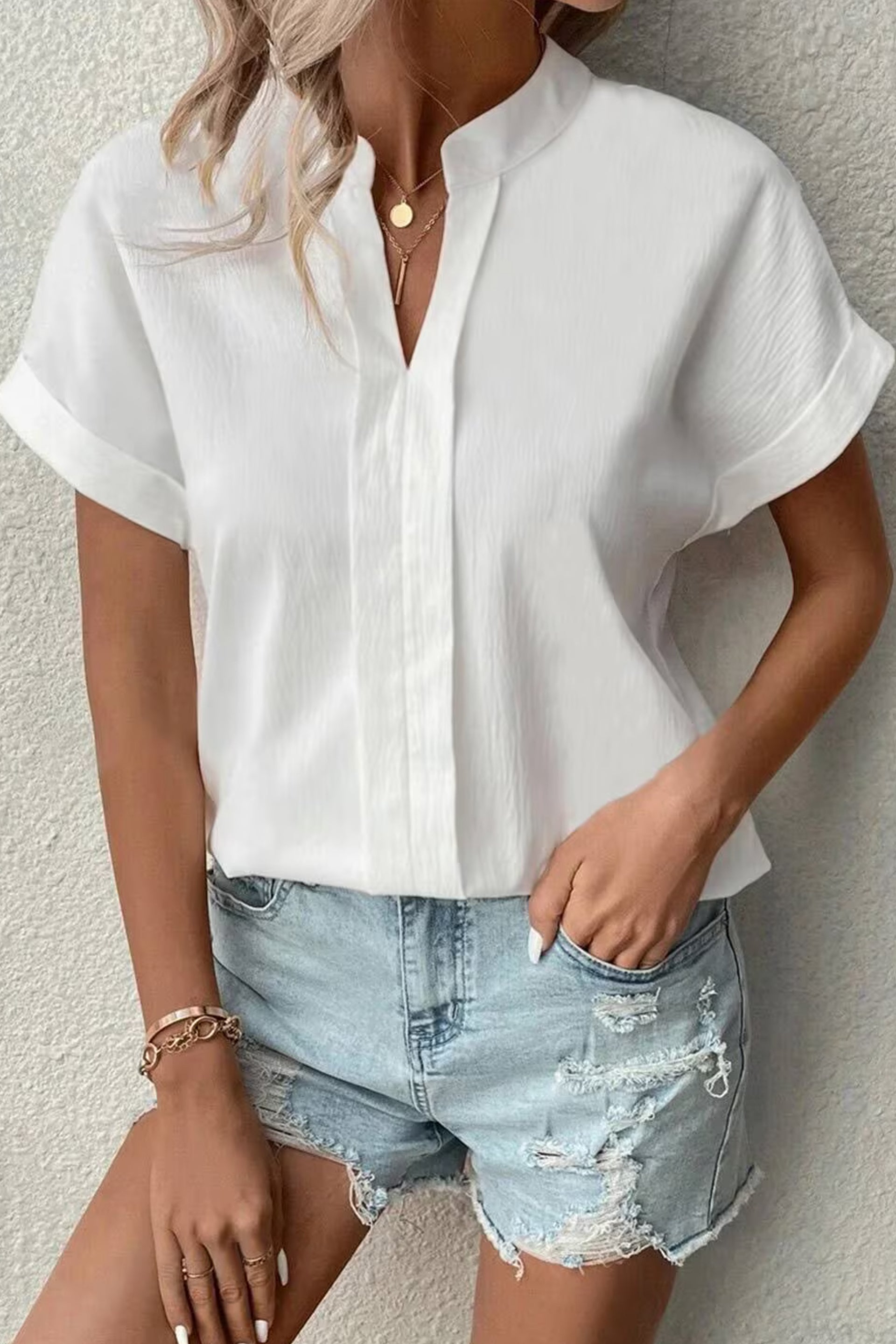 Stylish white summer top for women online paired with denim shorts, perfect for casual outings