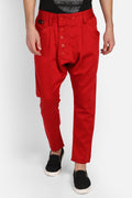 Stylish model wearing trendy red harem pants with button details and a relaxed fit